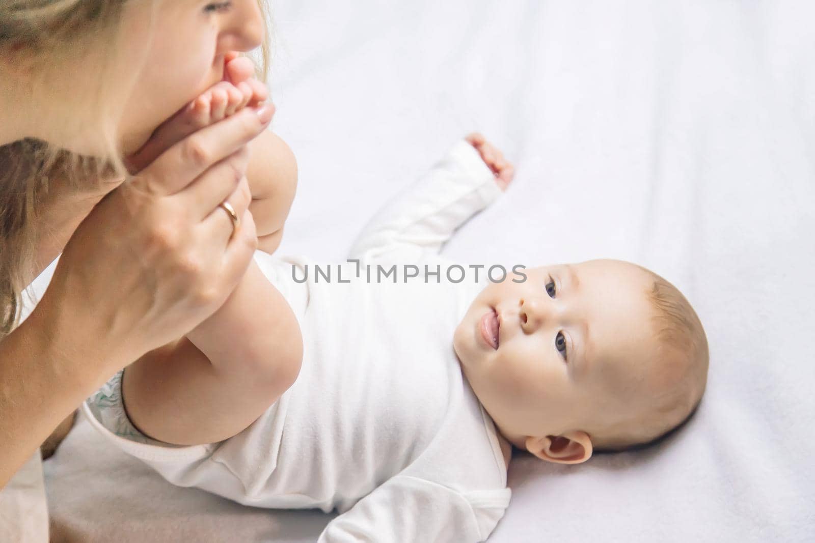 Mother with baby on a light background. Selective focus. People.