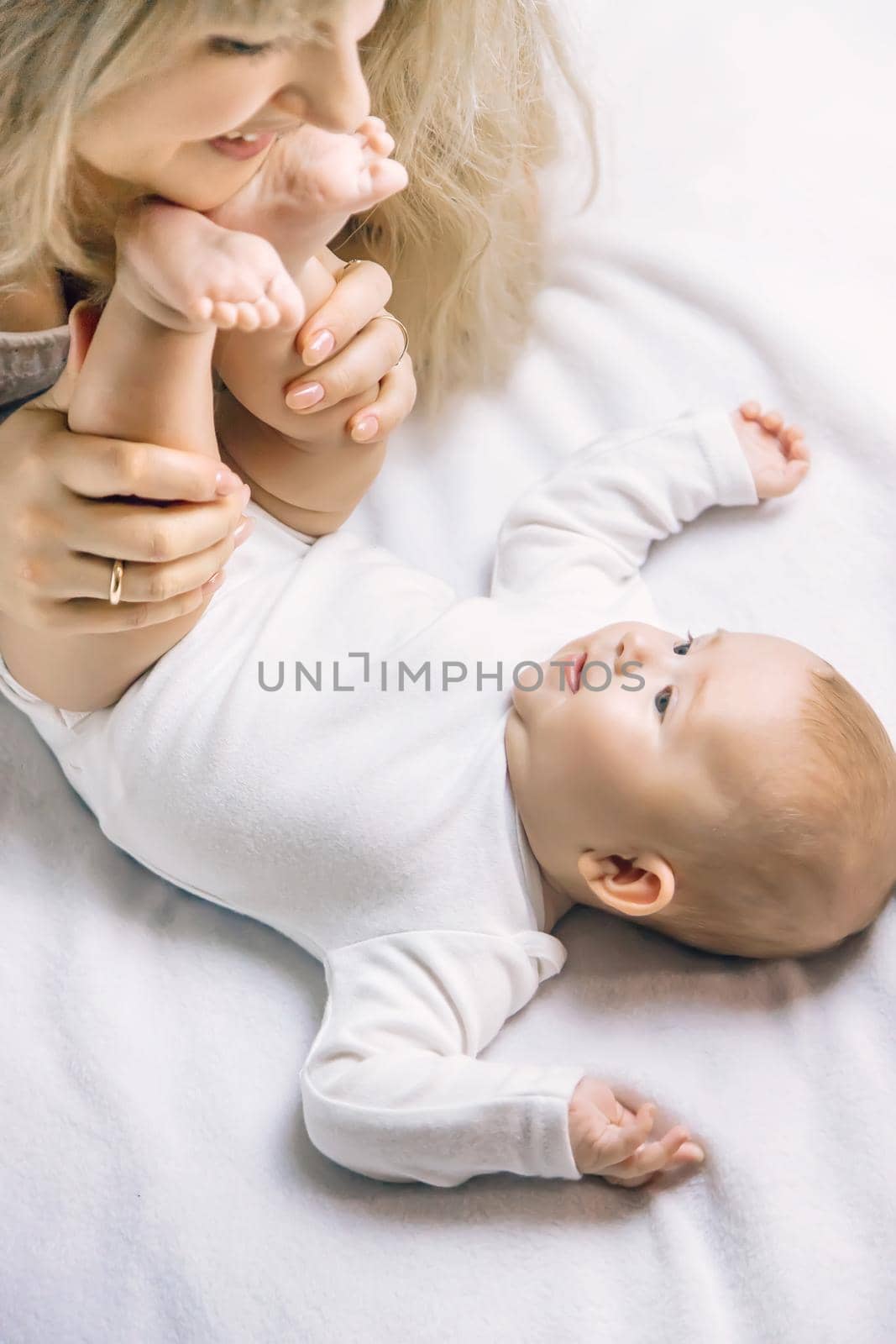 Mother with baby on a light background. Selective focus. People.