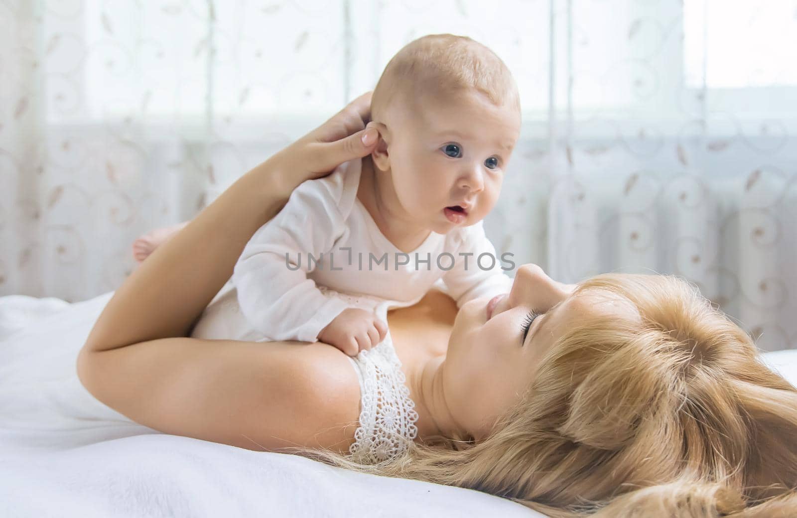 Mother with baby on a light background. Selective focus. People.