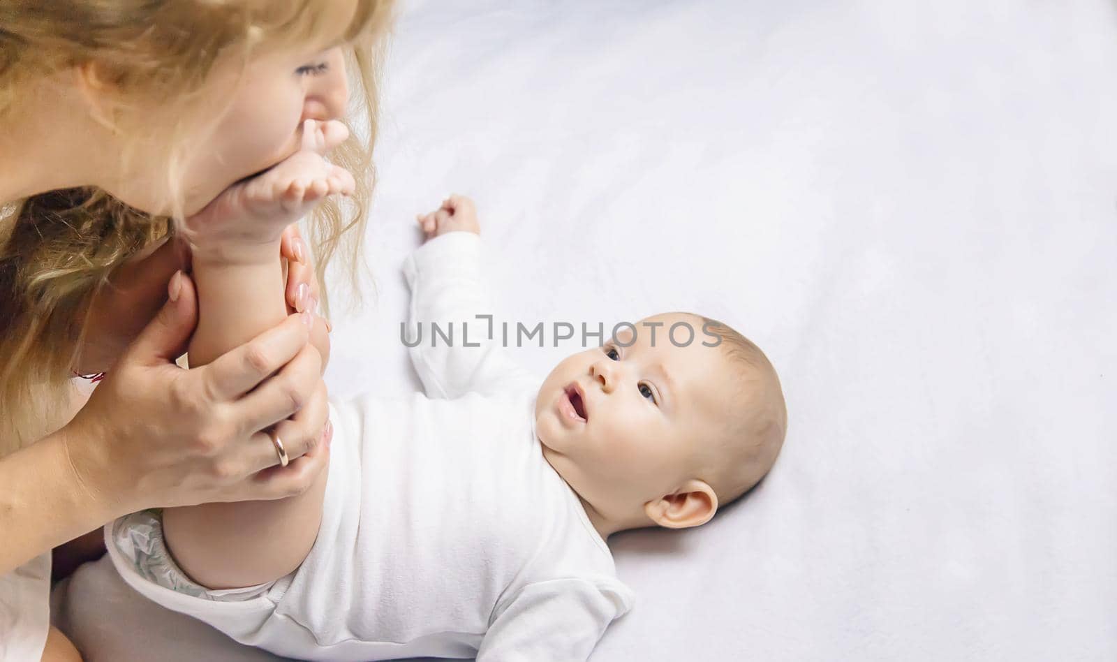 Mother with baby on a light background. Selective focus. People.