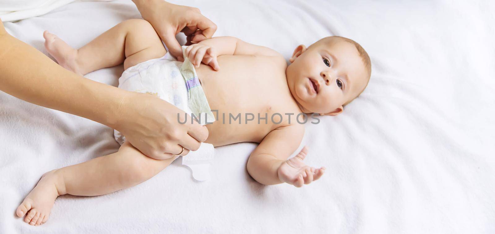 The mother changes the baby's diaper. Selective focus. by yanadjana