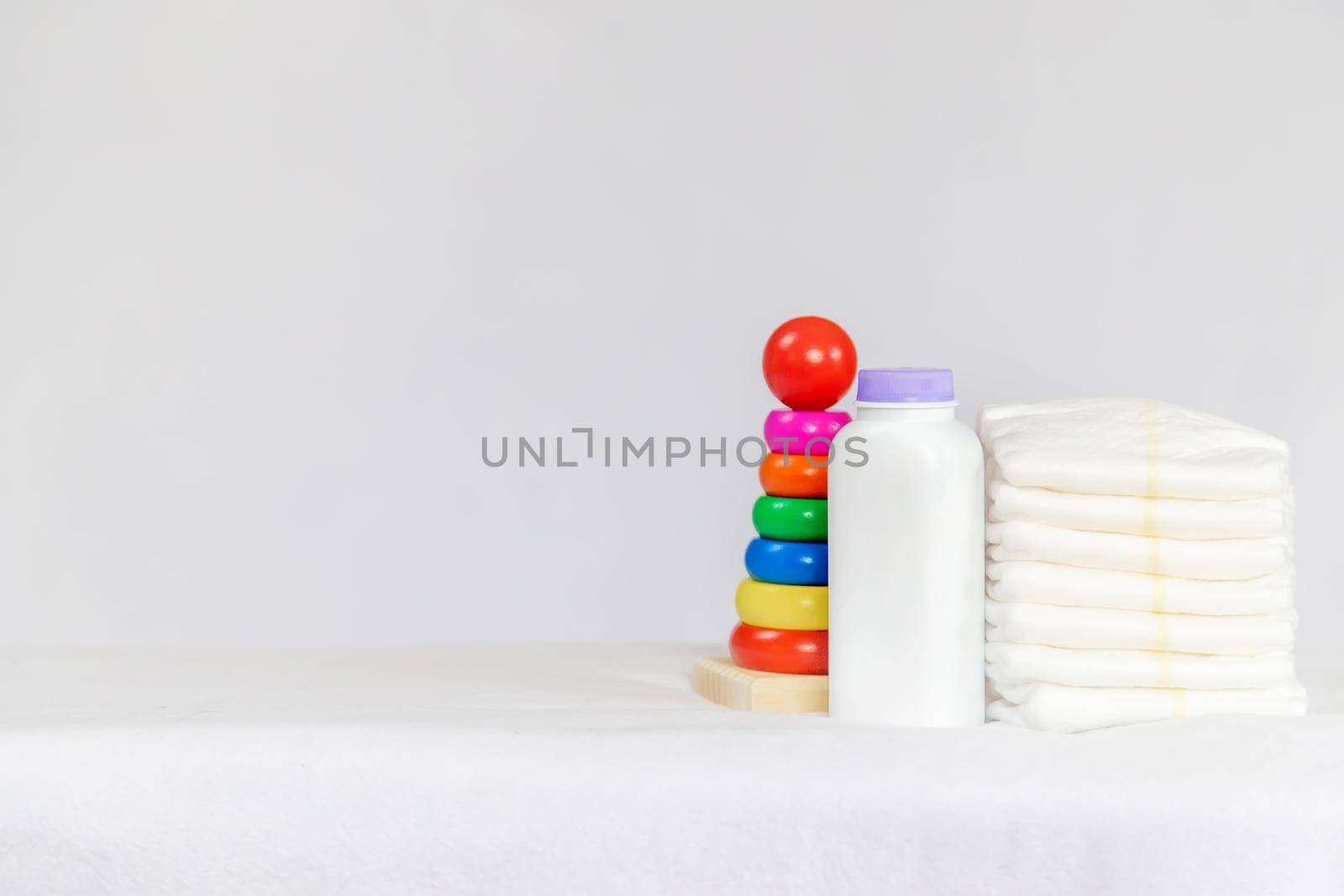 baby diapers and powder on a light background. Selective focus. accessories