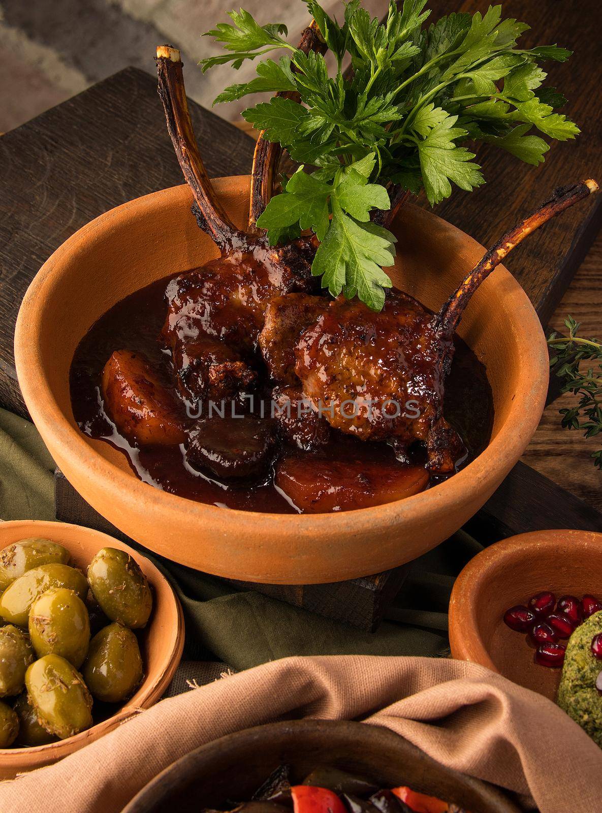 A vertical shot of a tomahawk steak and appetizers