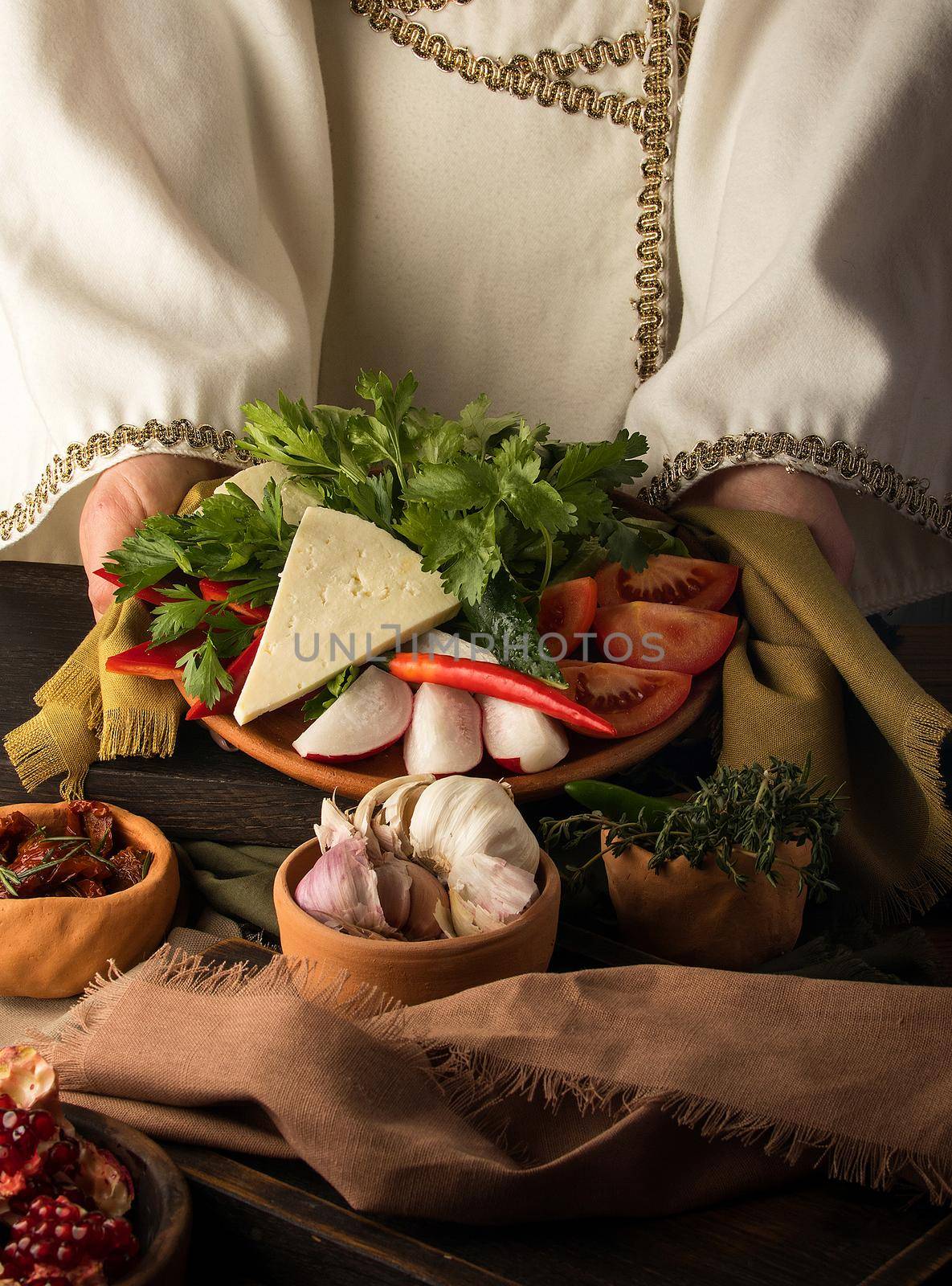 A vertical shot of a waitress presenting a appetizer dish