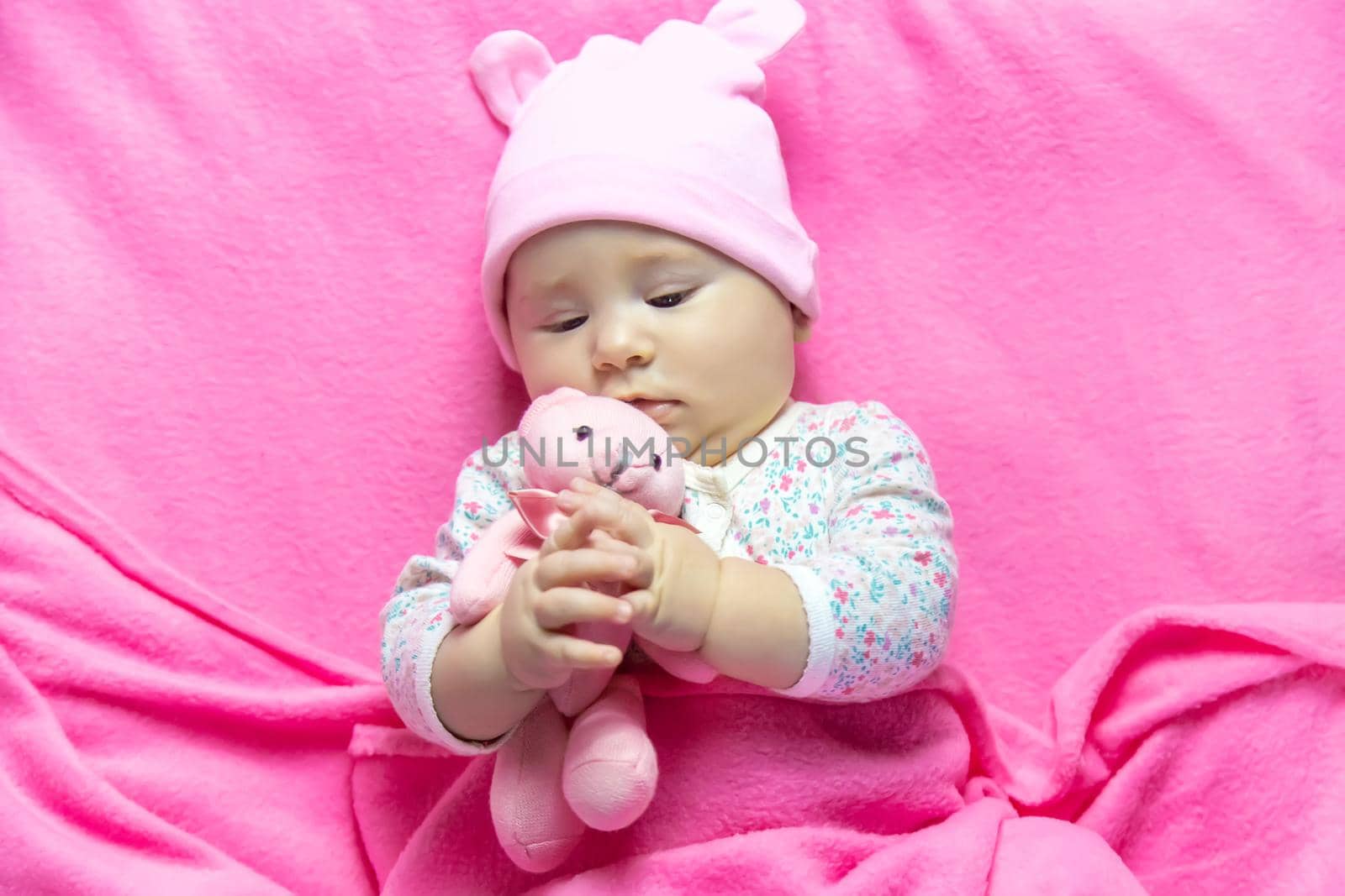 Baby sleeps with a bear. Selective focus. people.