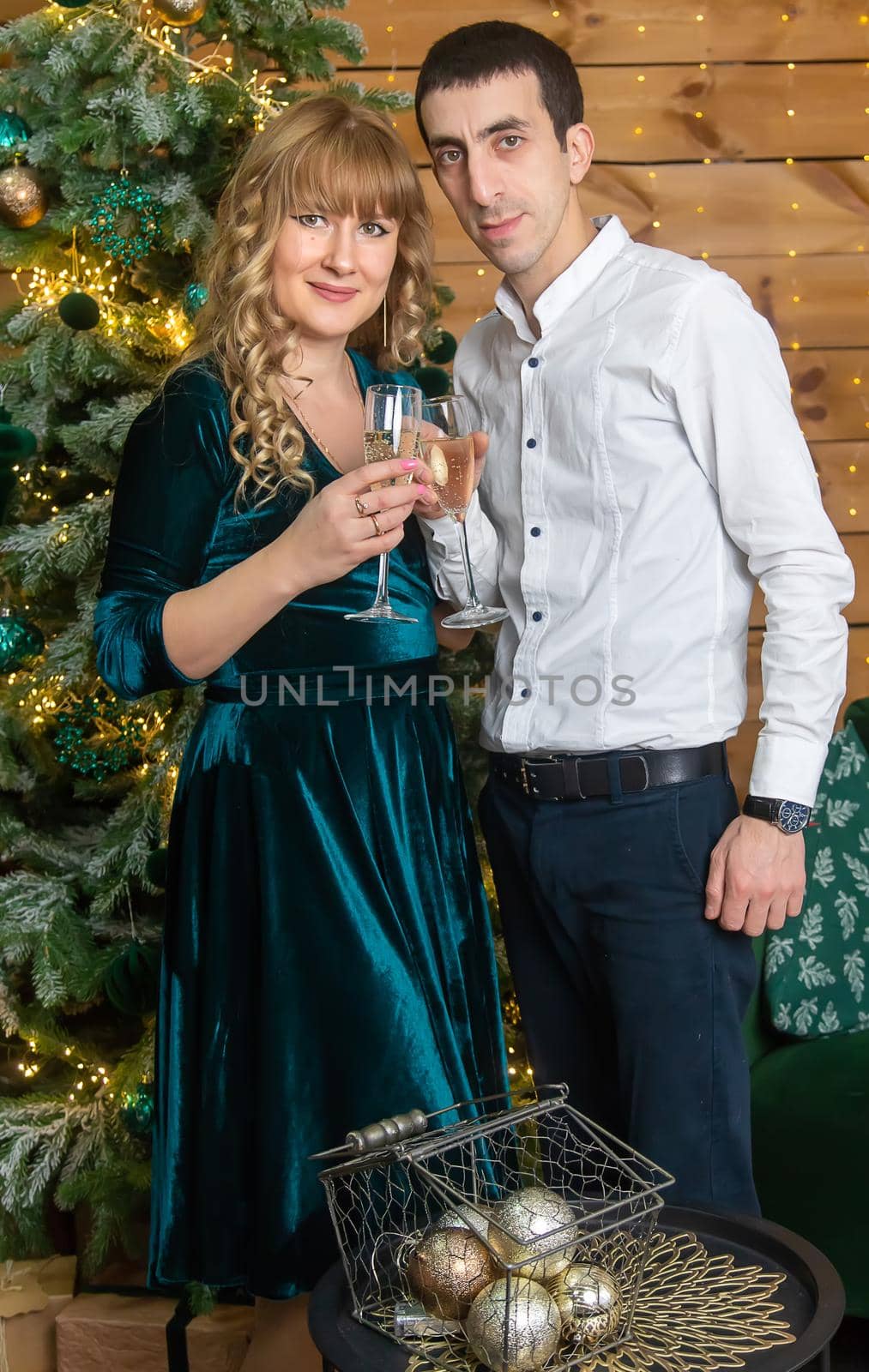 Christmas man and woman with glasses of champagne. Selective focus. Holiday.