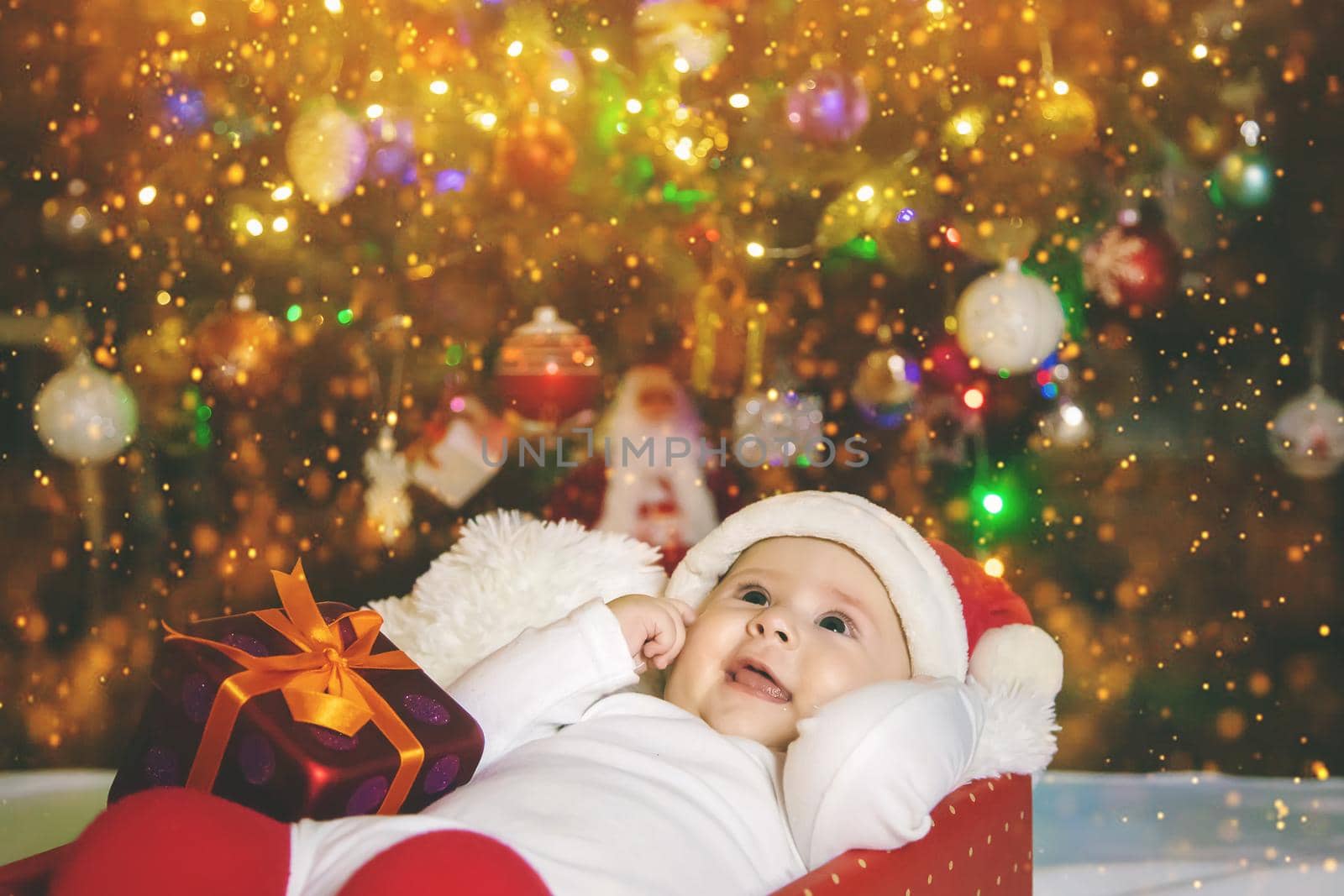 Baby is under the tree, Christmas. Selective focus. Holiday.