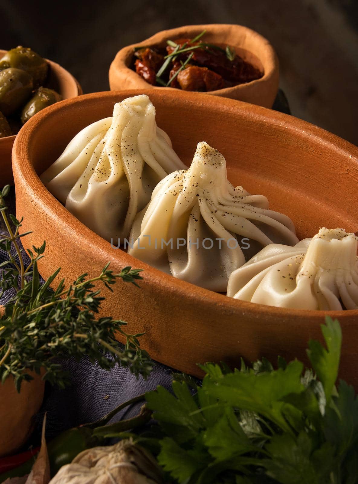 A vertical shot of a luxurious restaurant table with a gourmet khinkali dish