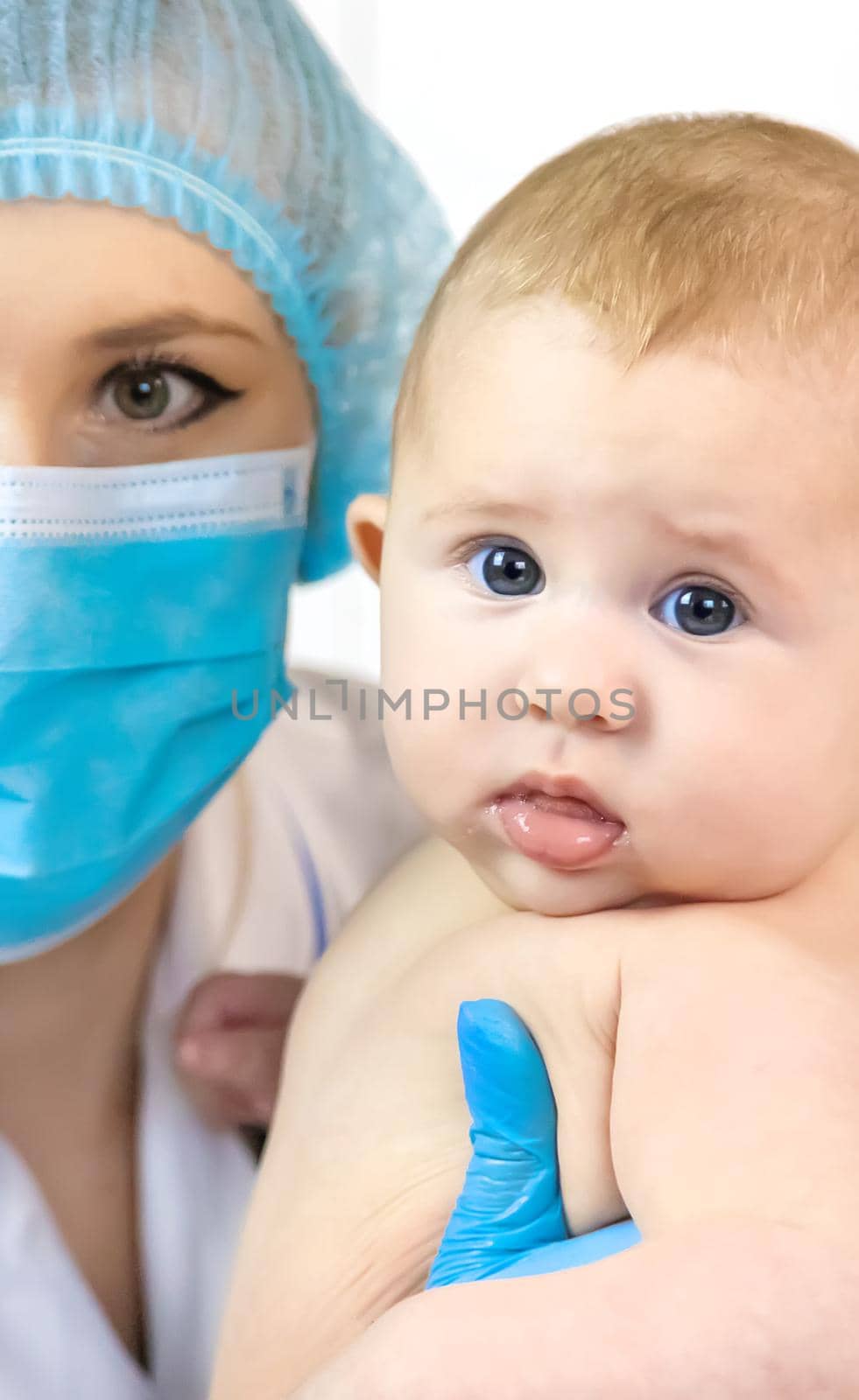 The baby is examined by a pediatrician at the hospital. Selective focus. people.