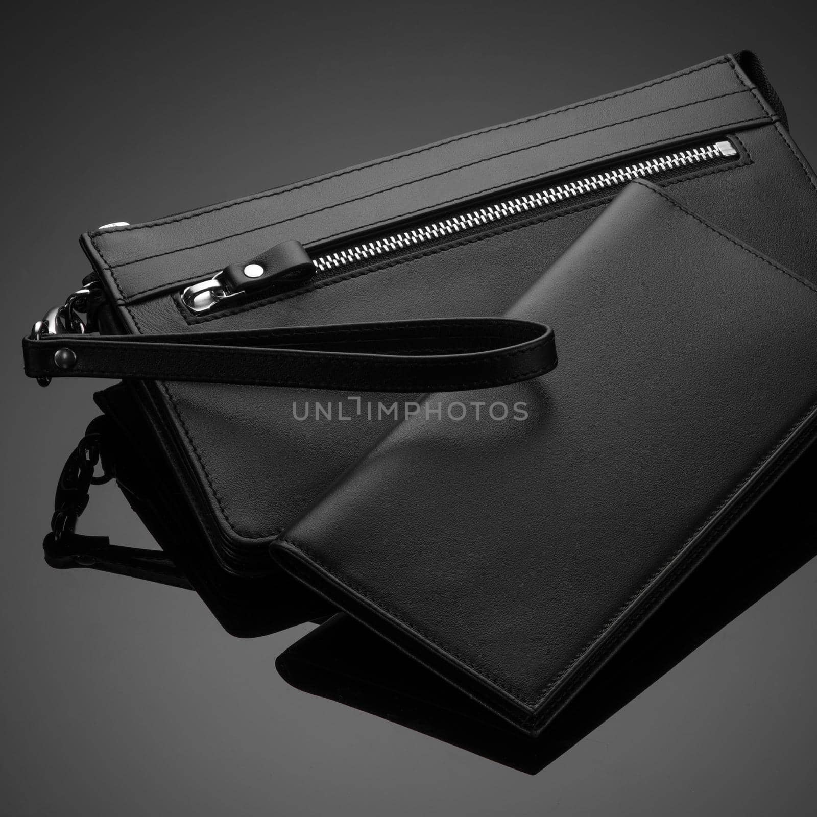 A closeup of a fashionable leather men's wallet on a dark background