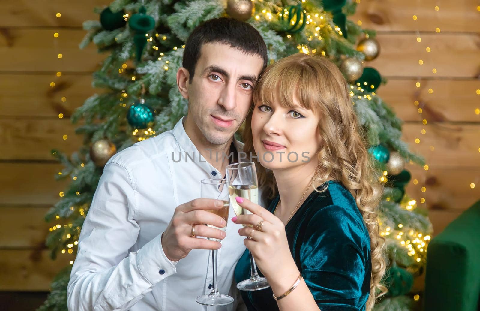 Christmas man and woman with glasses of champagne. Selective focus. Holiday.