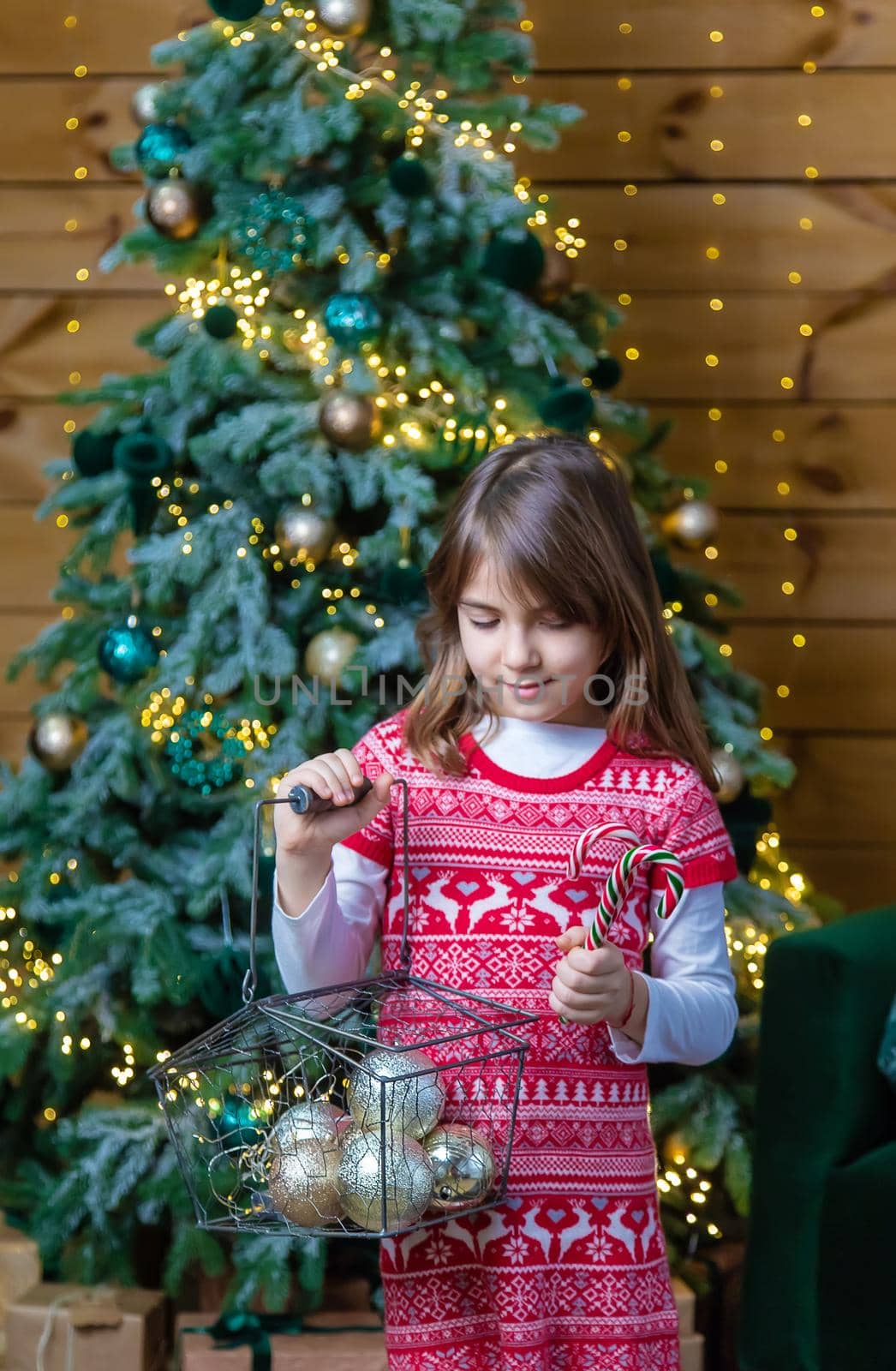 Child girl on a Christmas background. Selective focus. by yanadjana