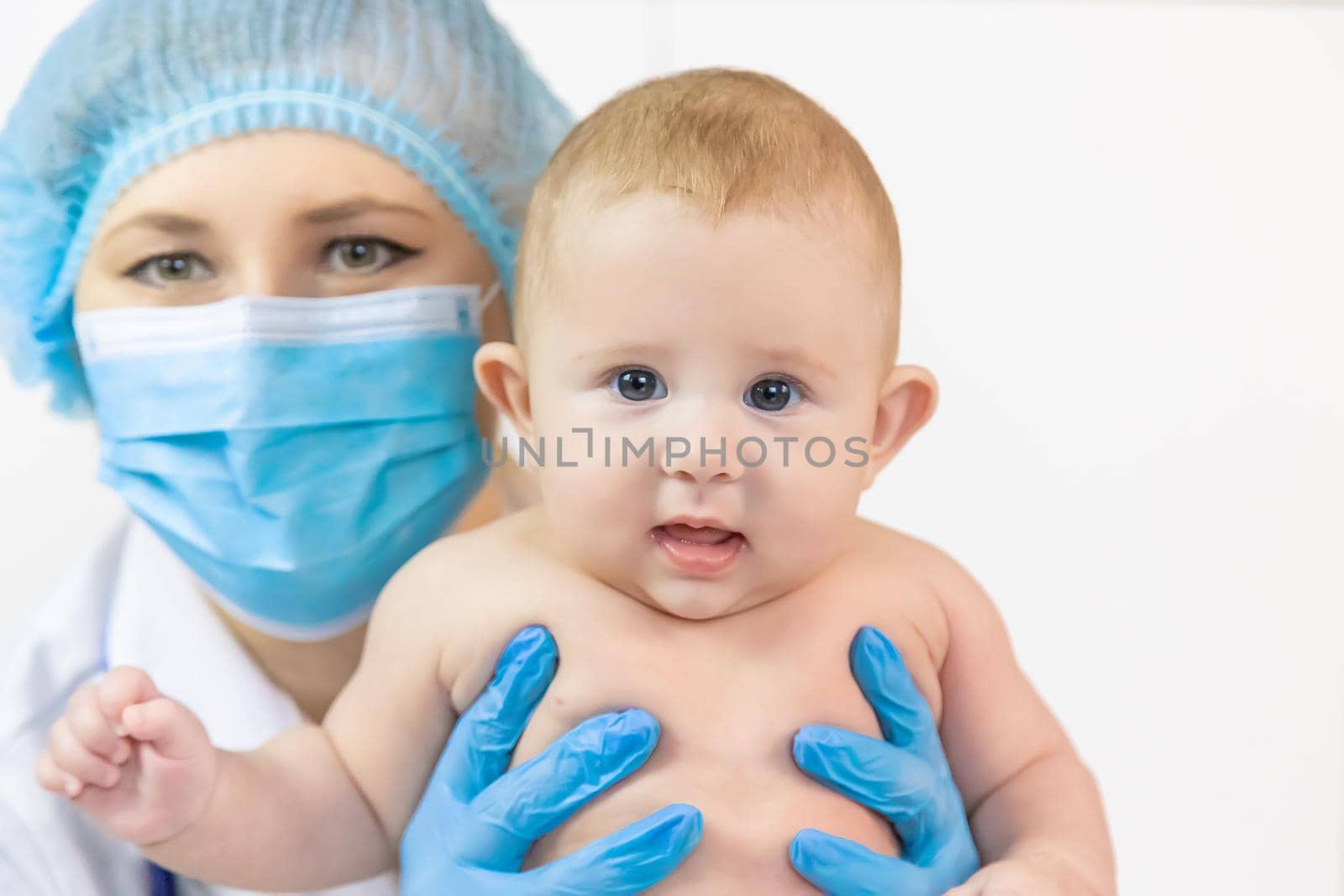 The baby is examined by a pediatrician at the hospital. Selective focus. people.