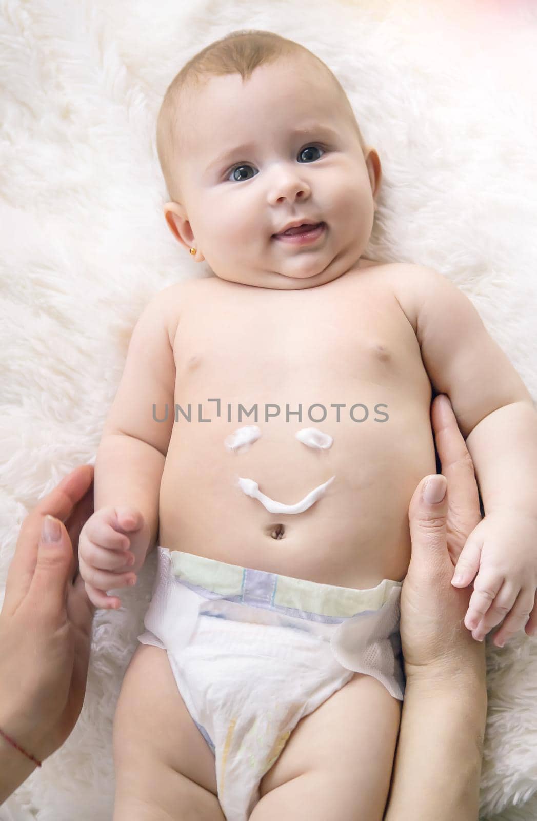 mother puts cream on little baby. Selective focus. Child.