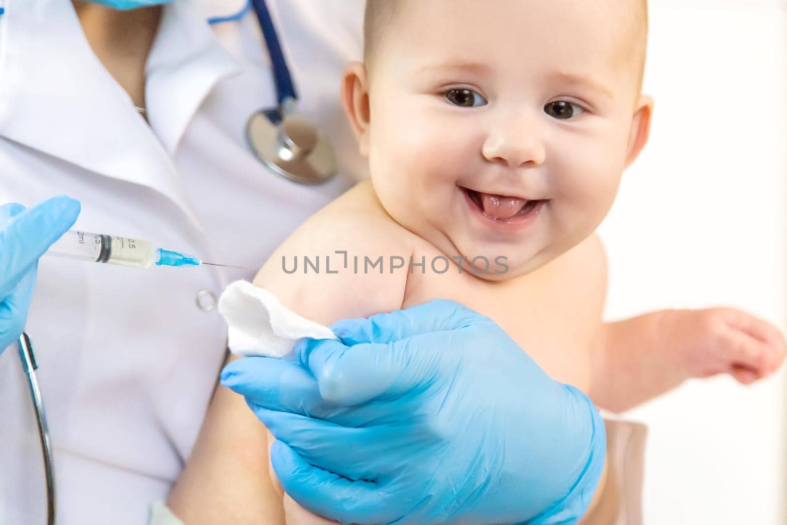 Vaccination of a baby by a doctor in a hospital. Selective focus. medicine.