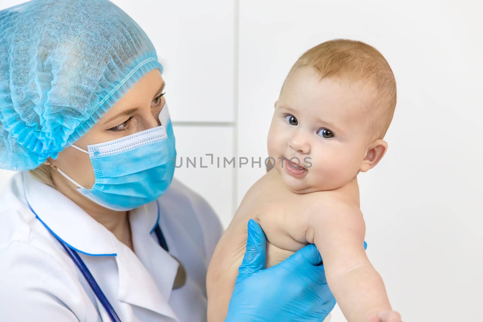 The baby is examined by a pediatrician at the hospital. Selective focus. people.