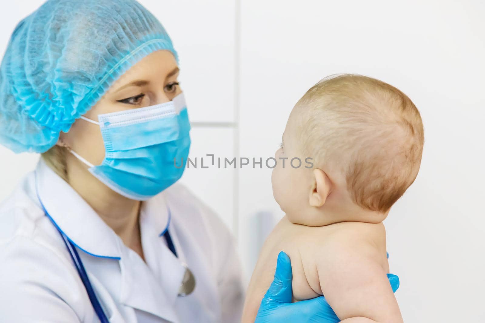 The baby is examined by a pediatrician at the hospital. Selective focus. people.