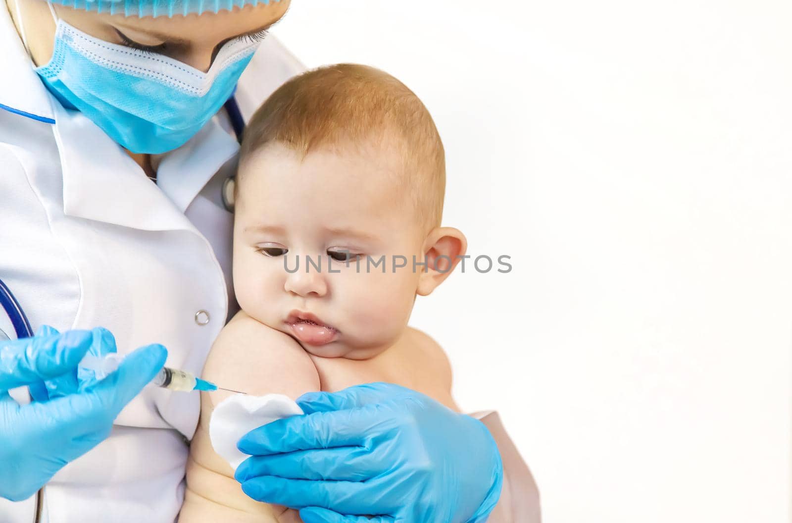 Vaccination of a baby by a doctor in a hospital. Selective focus. medicine.