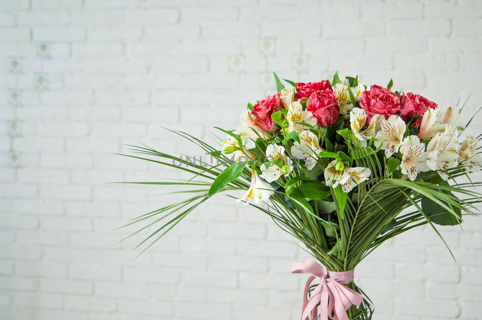 Beautiful bouquet with roses and white alstroemeria against a white wall by A_Karim