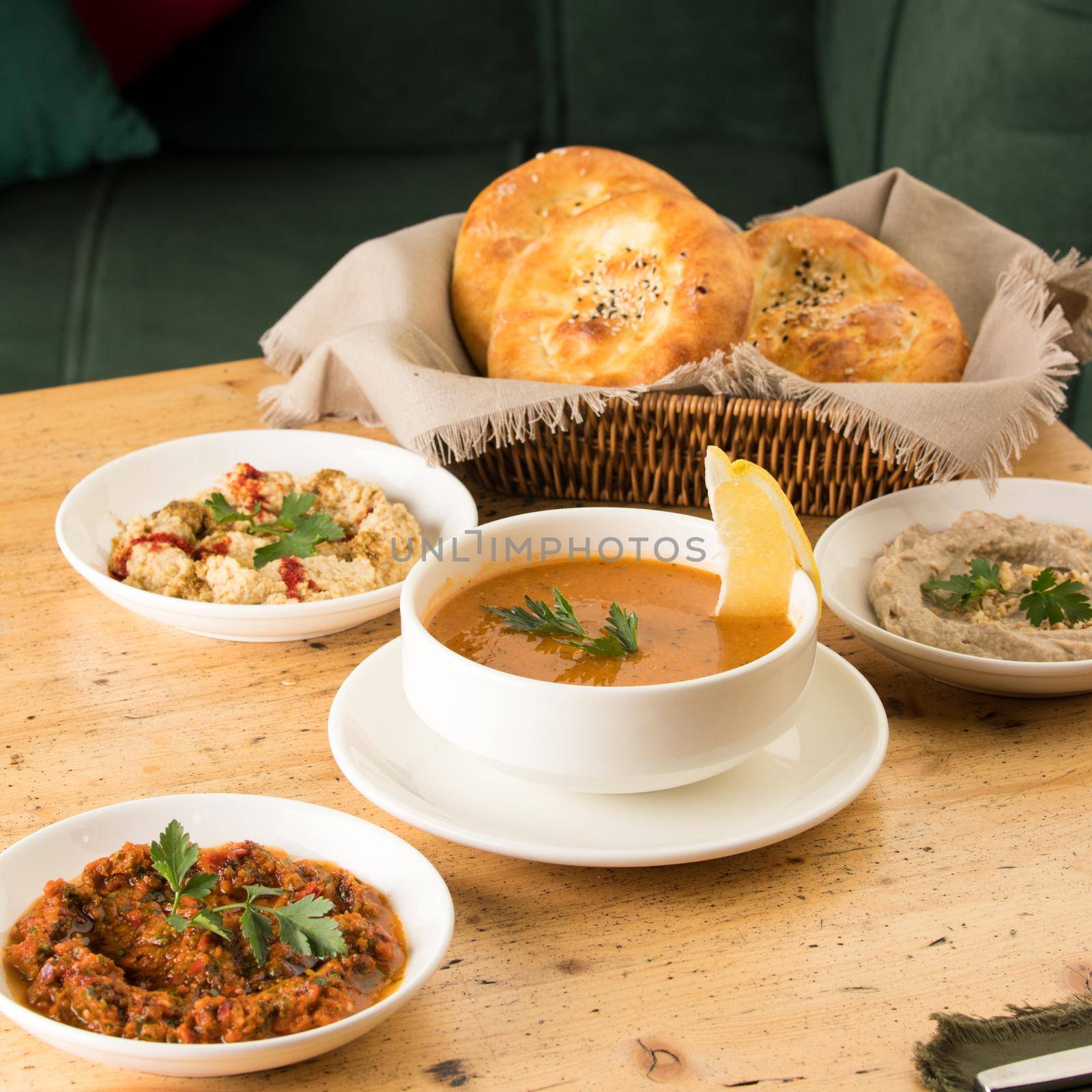 Closeup shot of a soup and appetizers near basket of breads by A_Karim