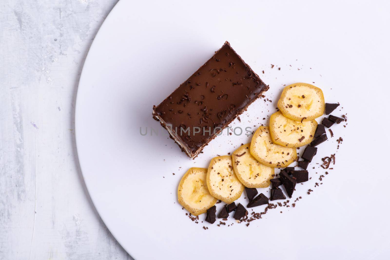 Serving of delicious chocolate cake pieces on a white plate by A_Karim