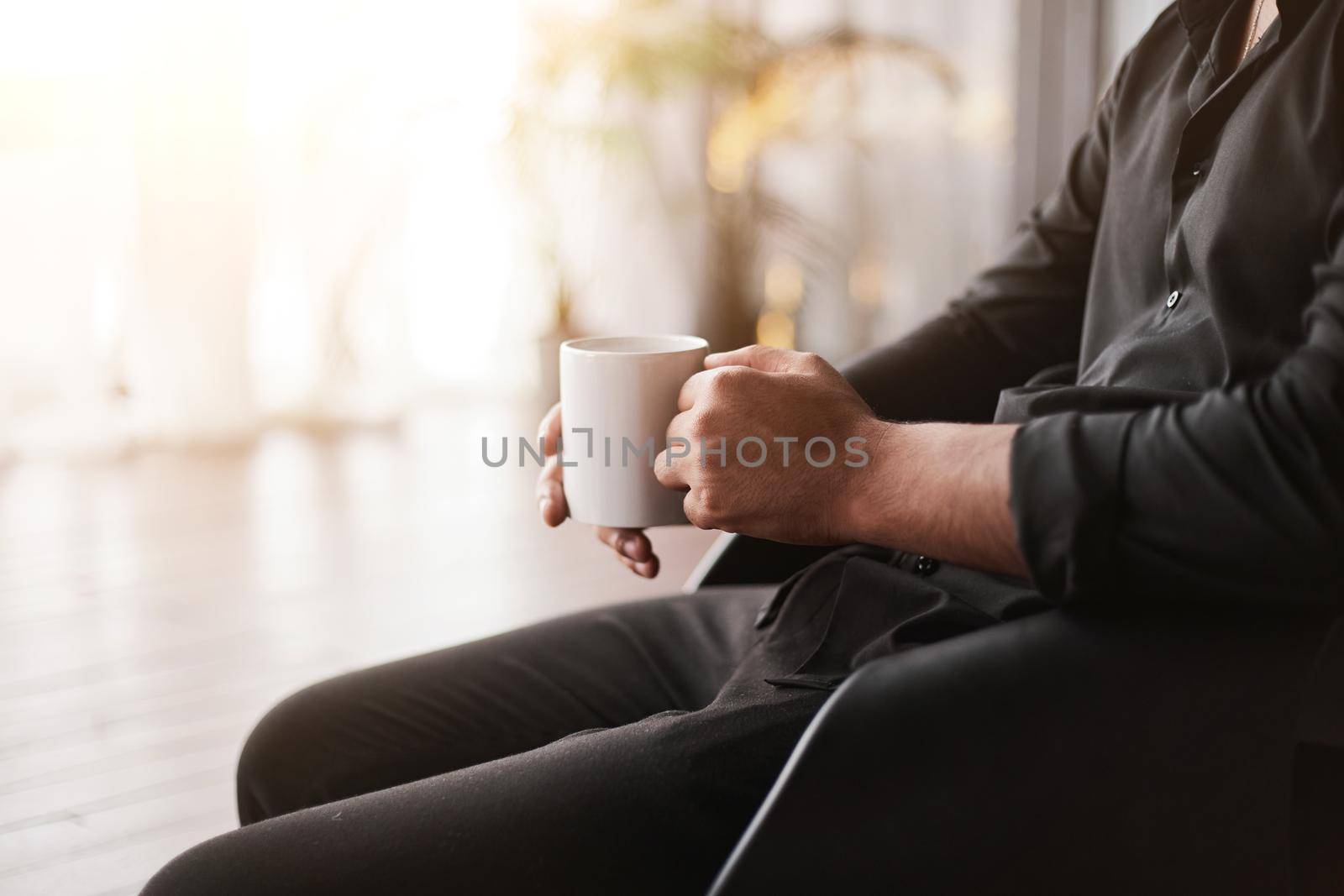 cropped image of a businessman with a cup of coffee. close-up.