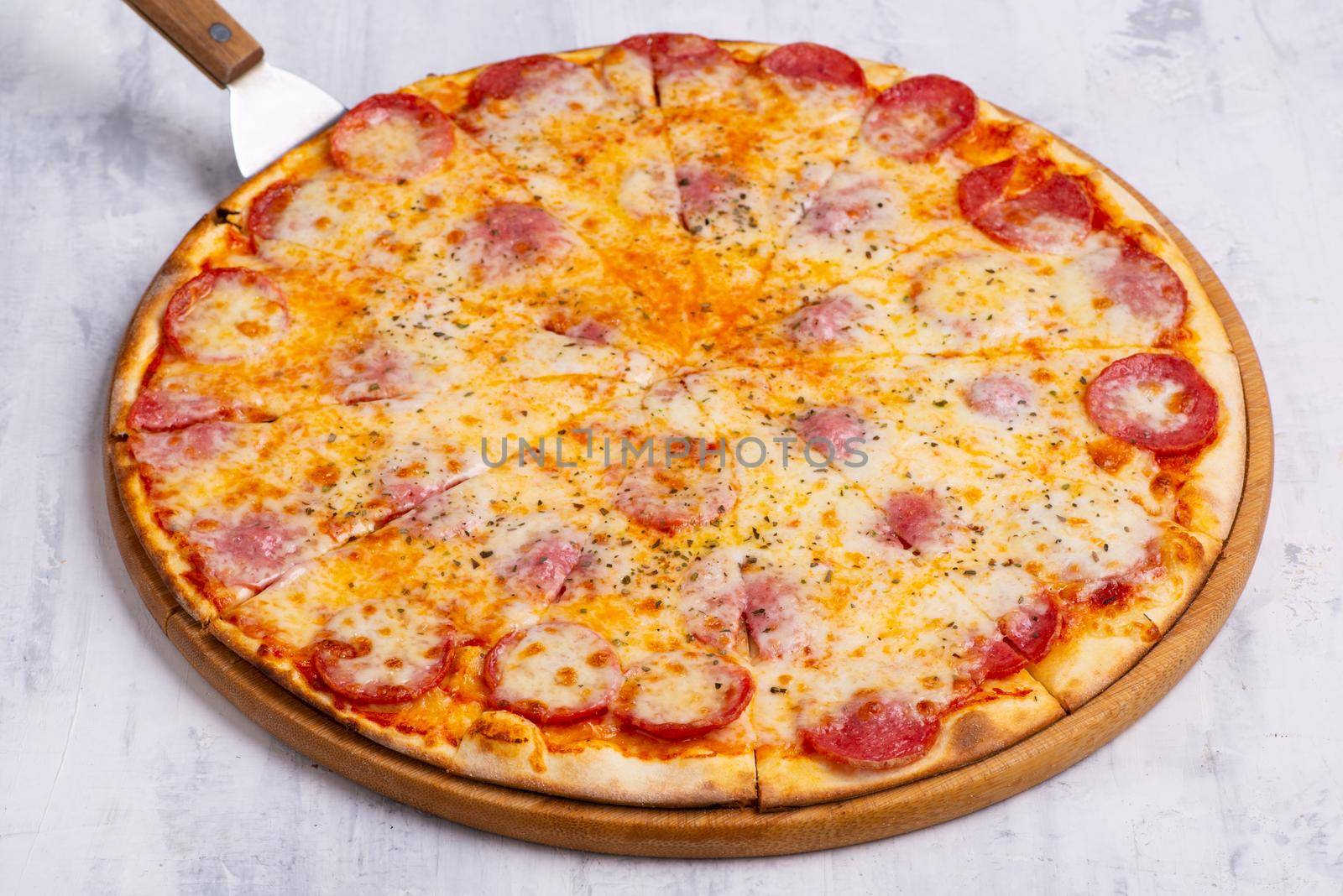 A closeup shot of a freshly baked pizza on a round tray