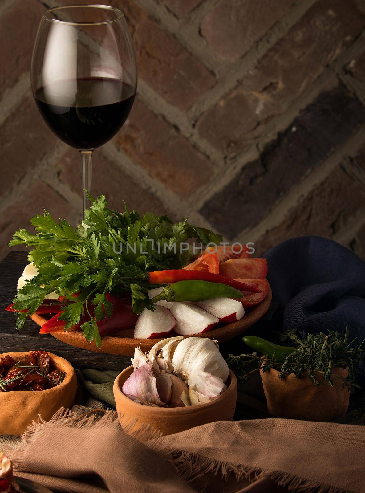 A vertical shot of appetizers and a glass of wine