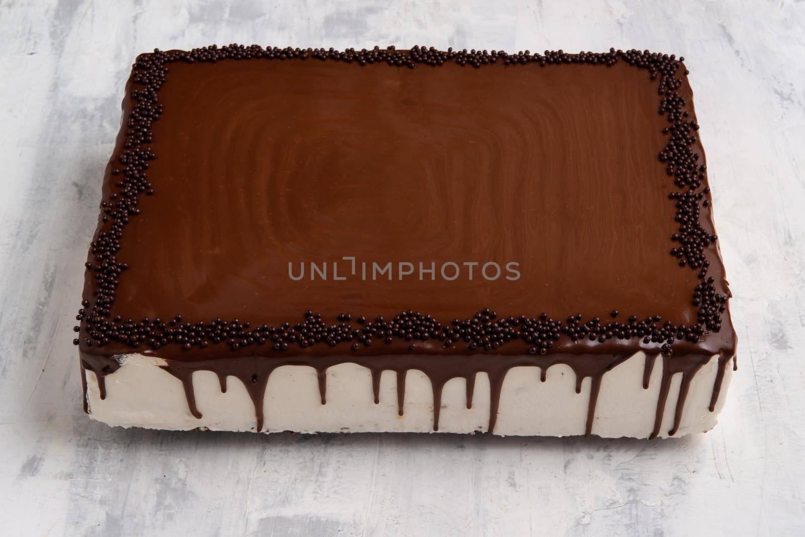 A closeup shot of a chocolate cake on a white plate