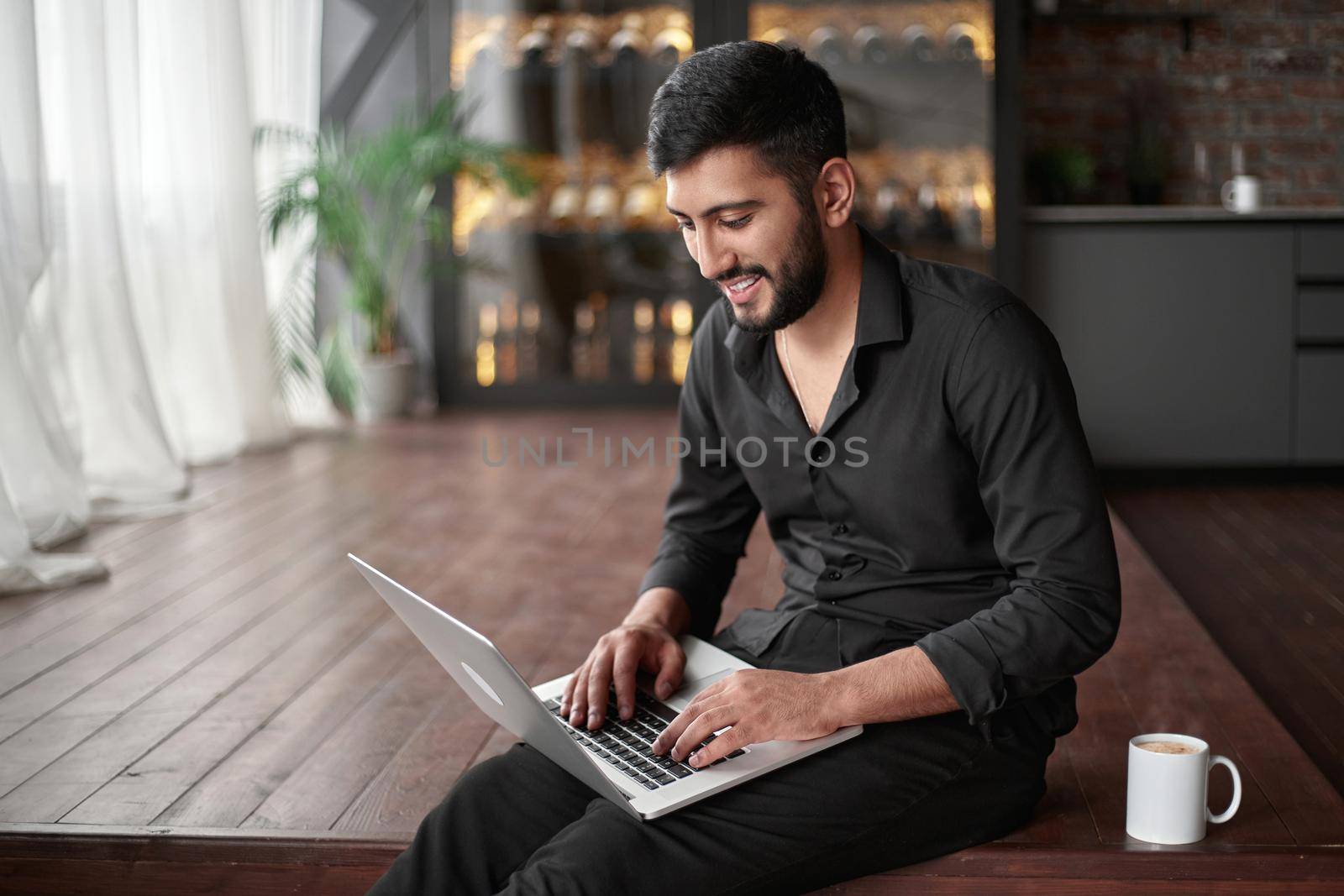 happy business owner using a laptop in his new cafe. concept of wireless technologies.