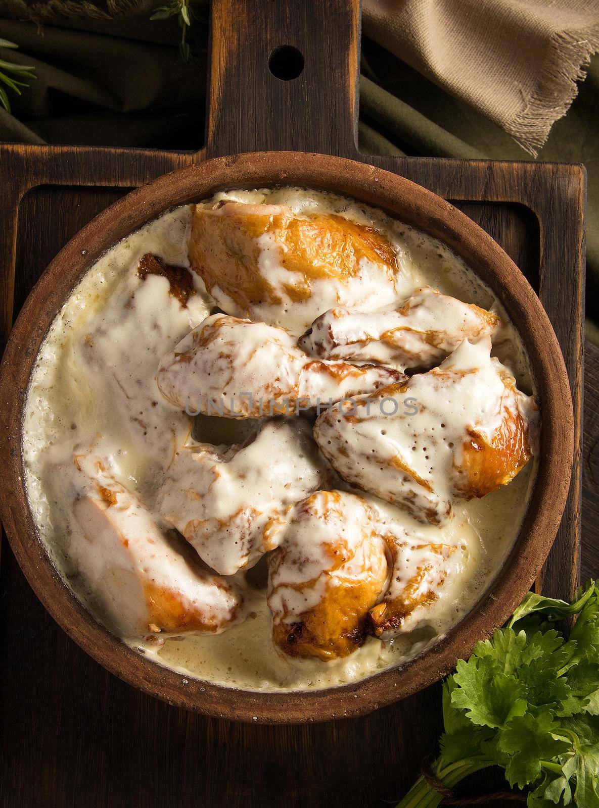 A top view of a chicken covered in a creamy sauce