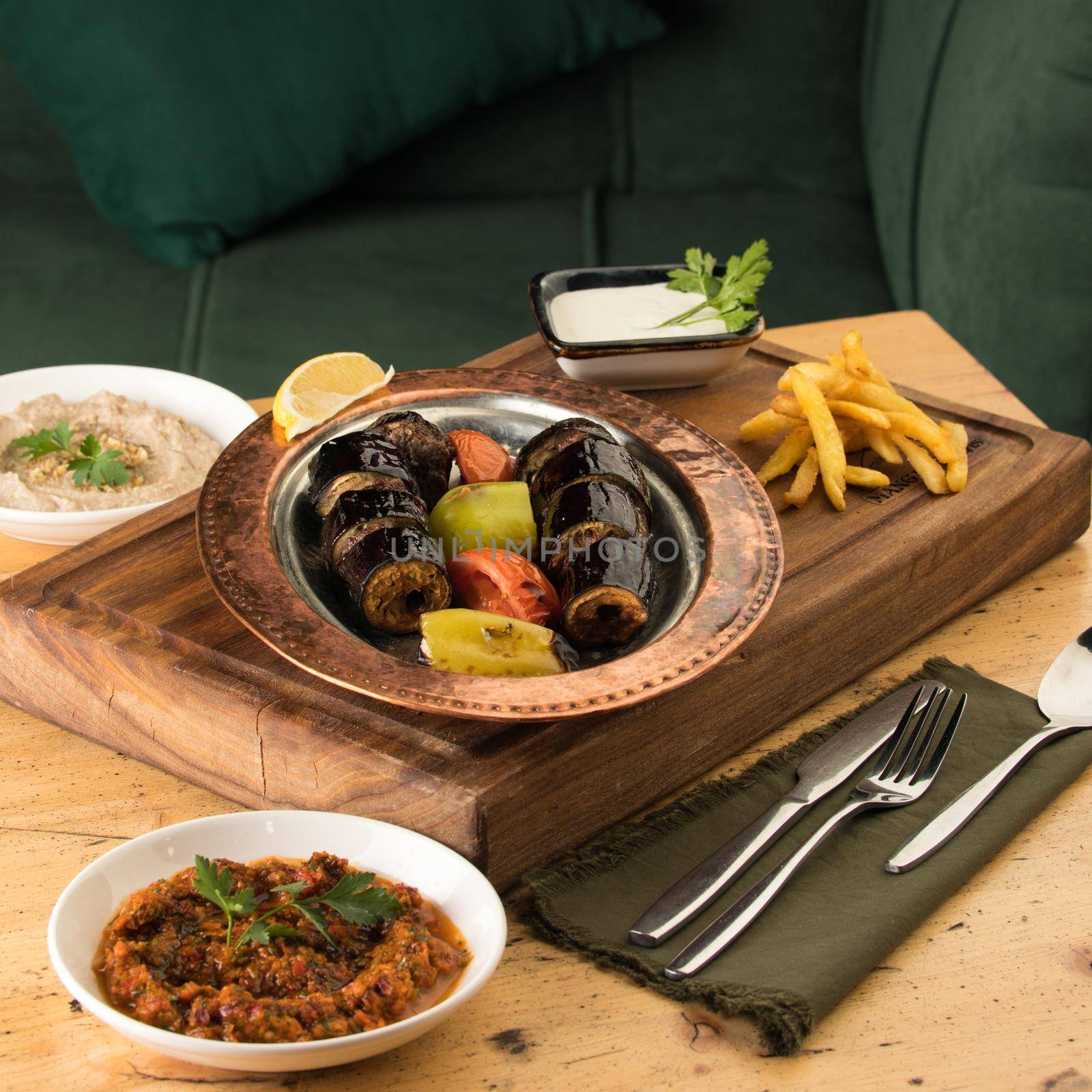 Dining table full of delicious dishes on a wooden desk by A_Karim