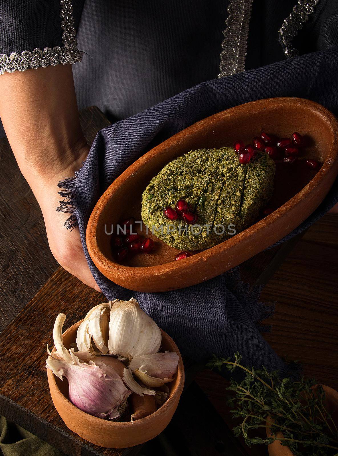 Vertical shot of a waitress presenting a pkhali by A_Karim