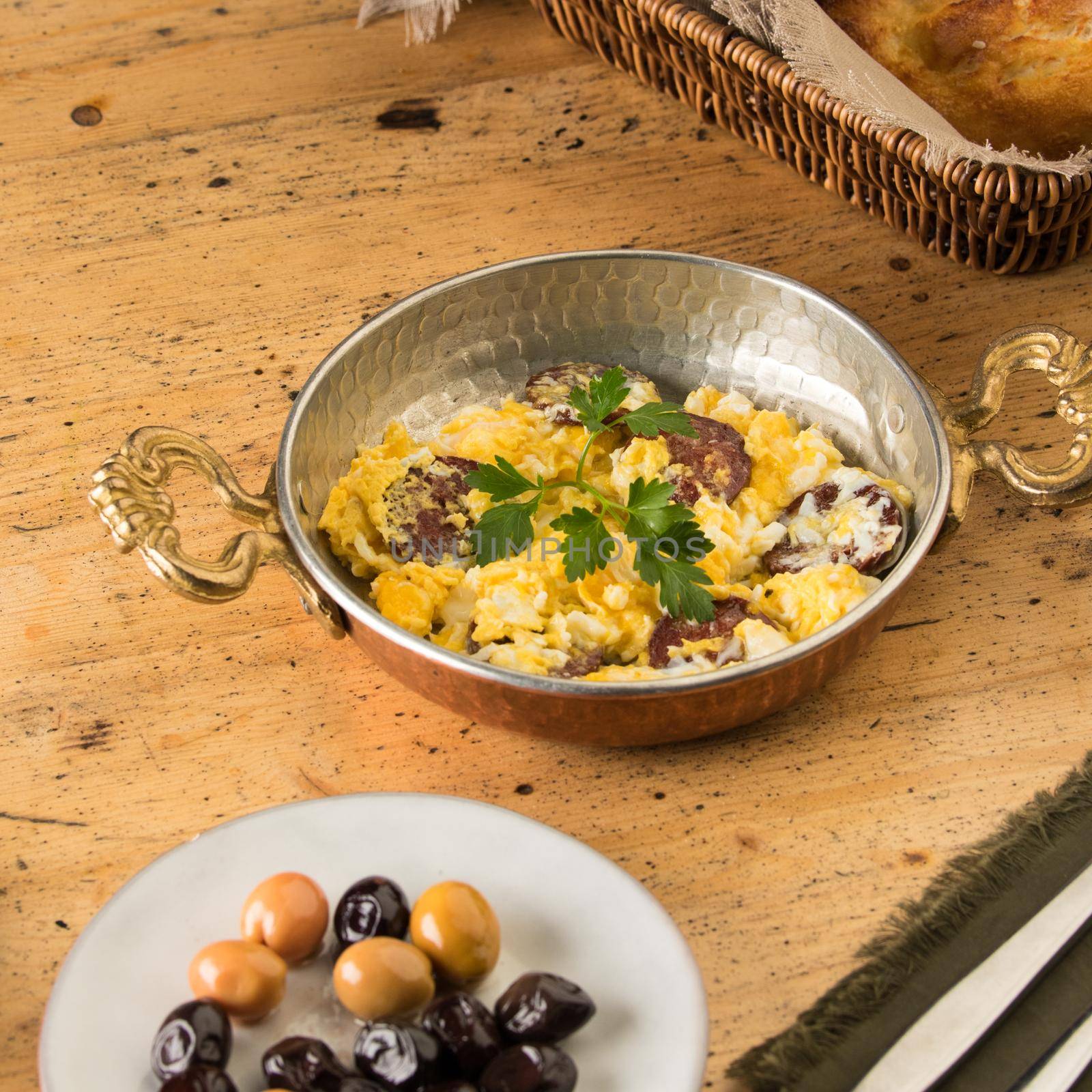 A closeup shot of deliciously prepared scrambled eggs with sausages