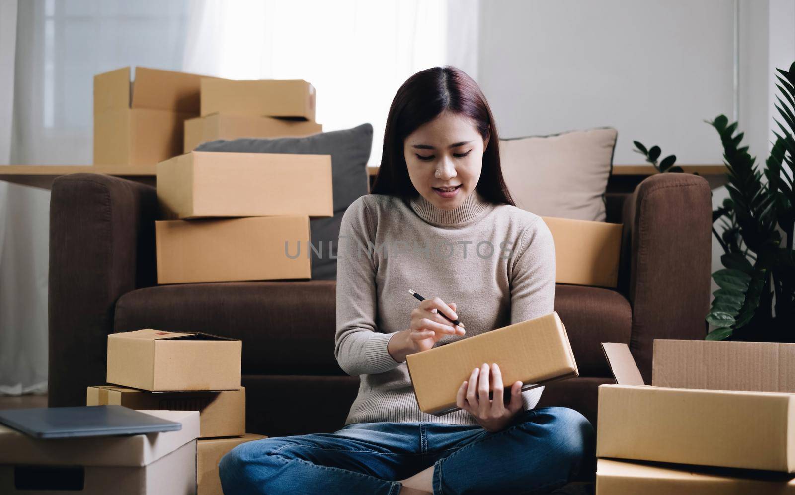 Starting small businesses SME owners female entrepreneurs Write the address on receipt box and check online orders to prepare to pack the boxes, sell to customers, sme business ideas online..