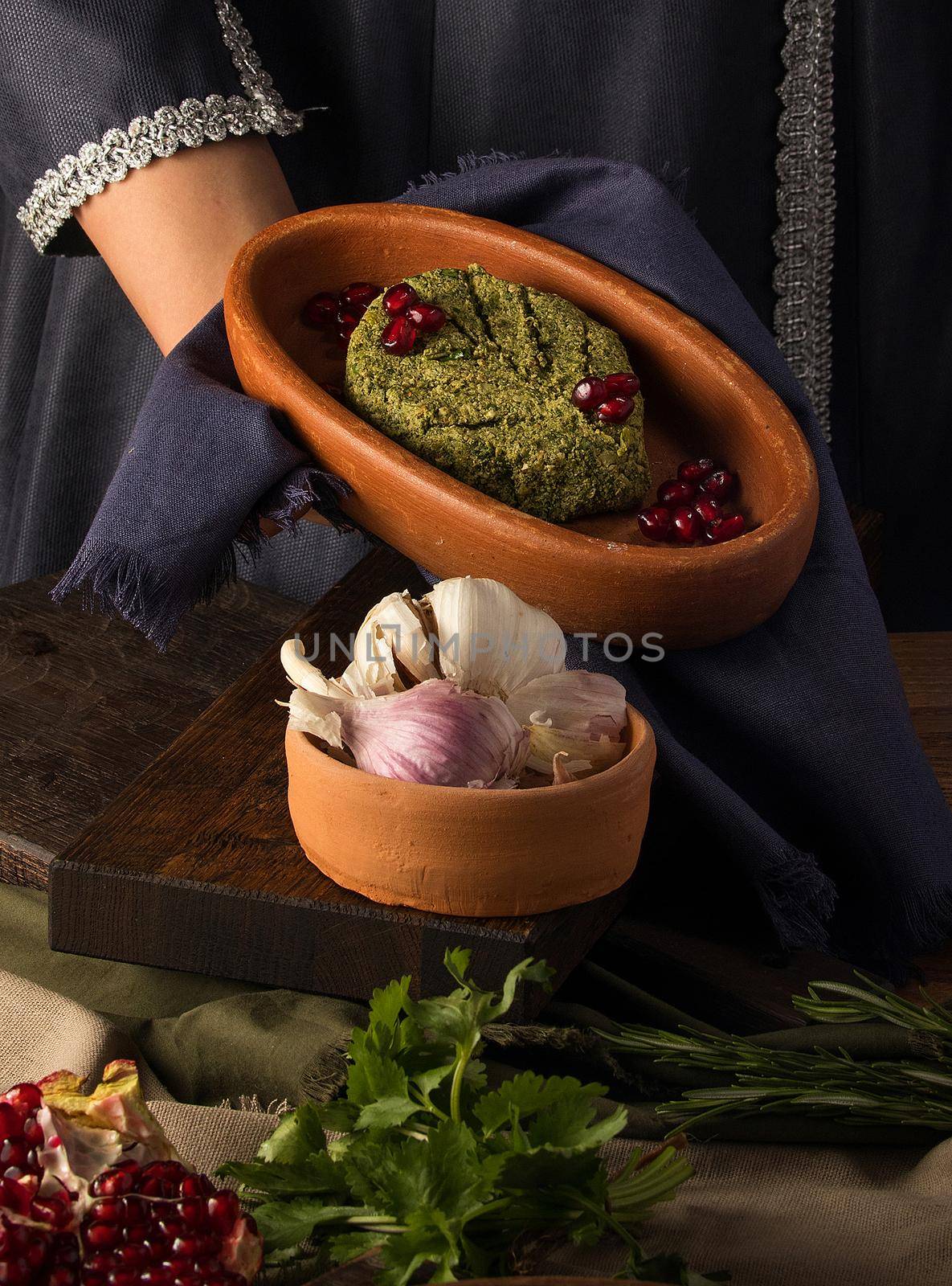 Vertical shot of a waitress presenting a pkhali by A_Karim