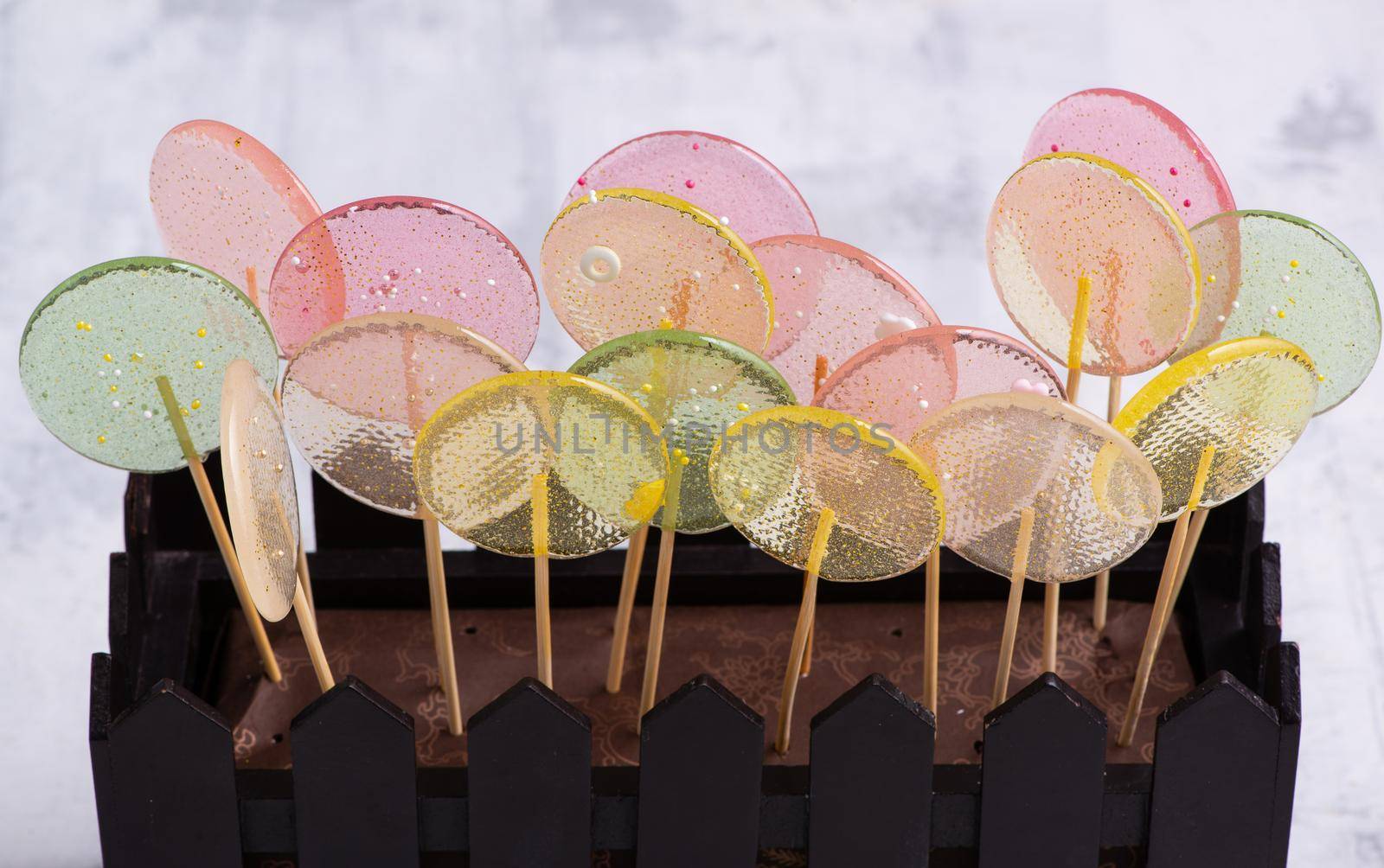A close-up shot of a whole brownie decorated with glass lollypops.