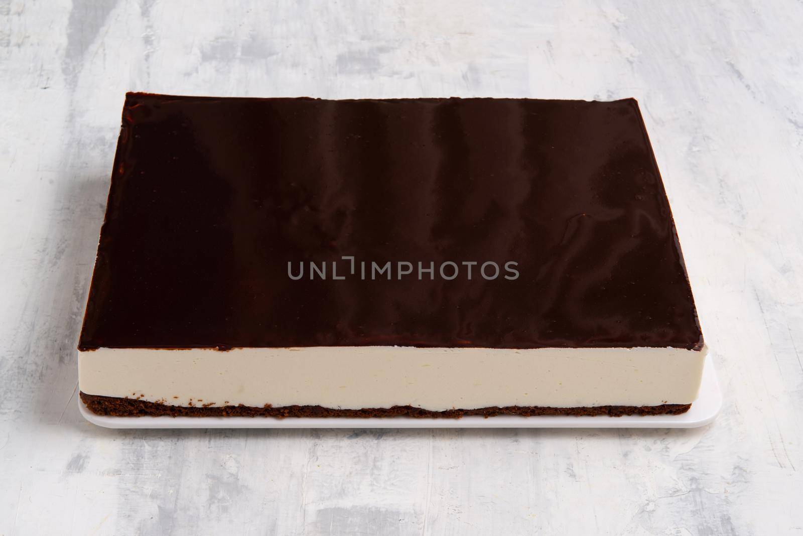 A closeup shot of a chocolate cake on a white plate