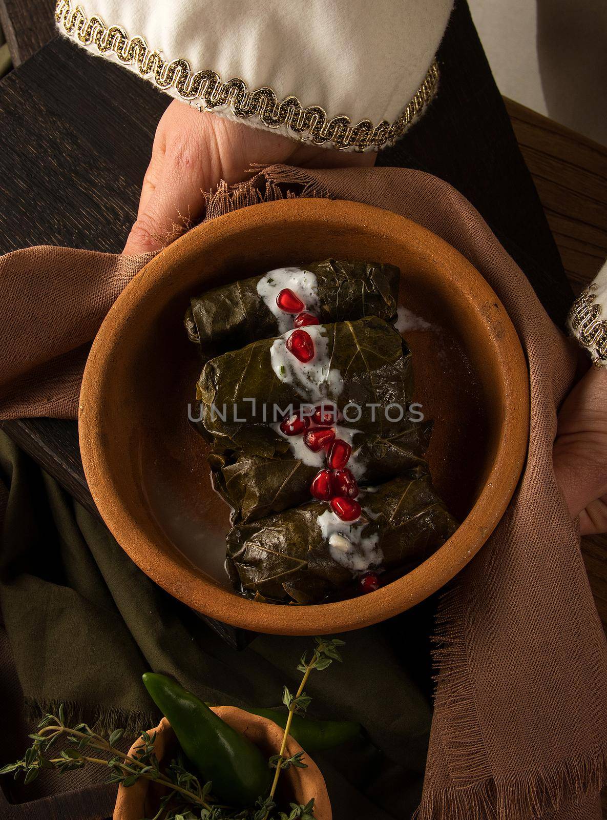A close up shot of a dolma covered in grape leaves
