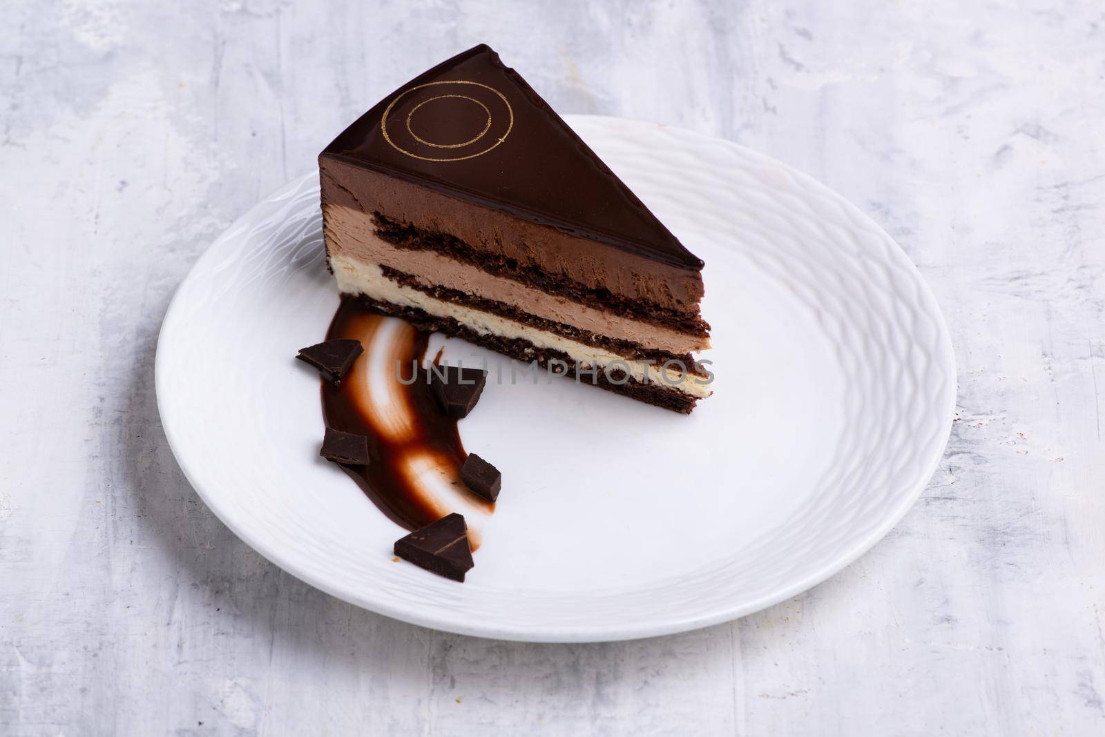 A top view shot of a chocolate cake slices on a white plate