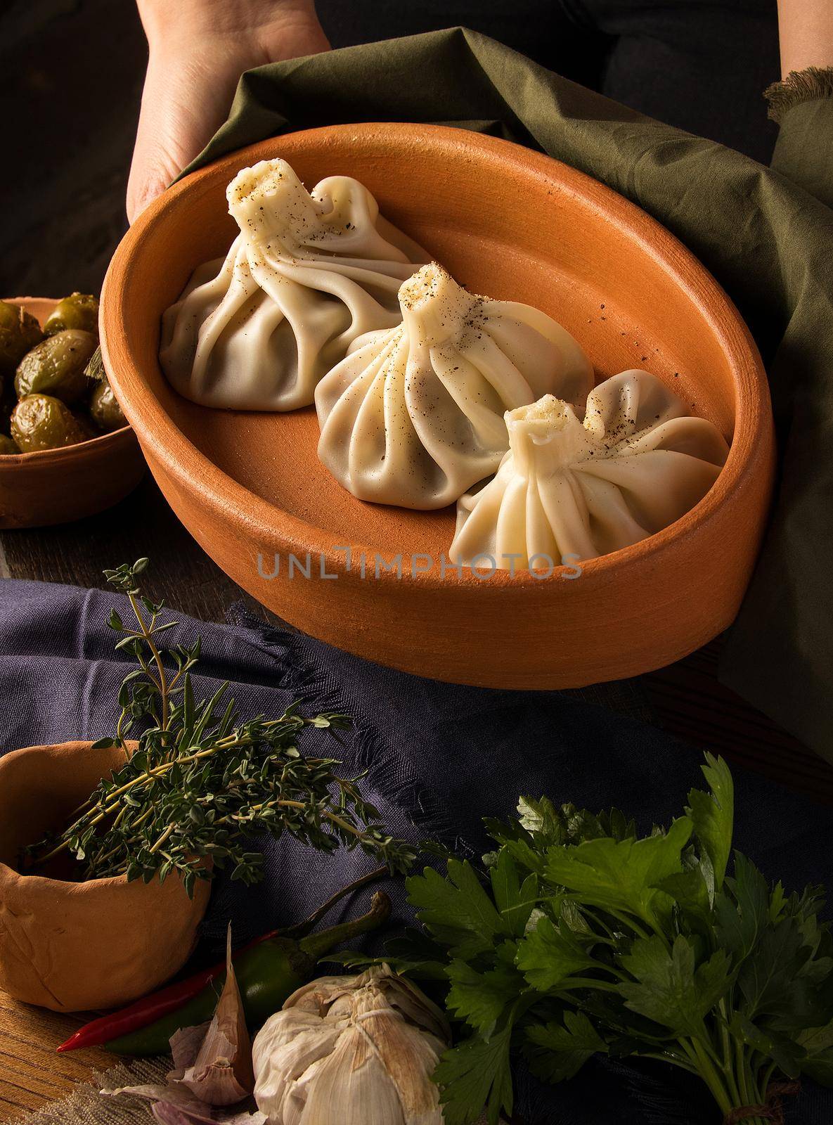 A vertical shot of a luxurious restaurant table with a gourmet khinkali dish