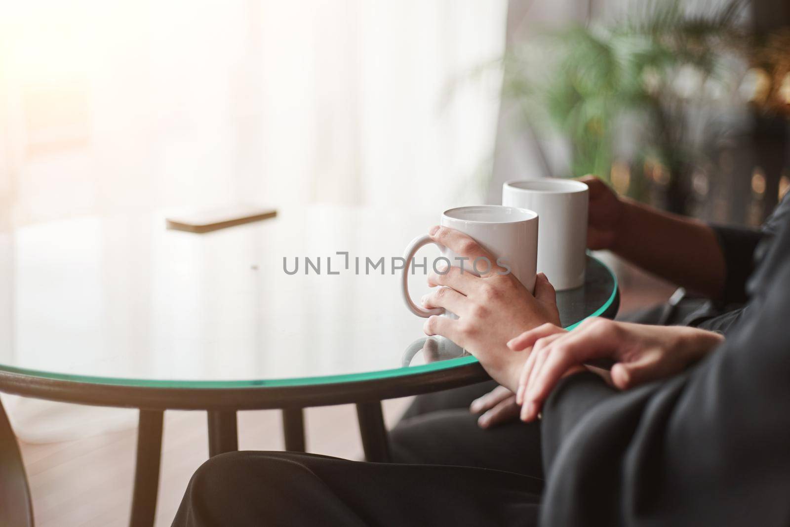 image of a man and a woman talking sitting at a coffee table. by SmartPhotoLab