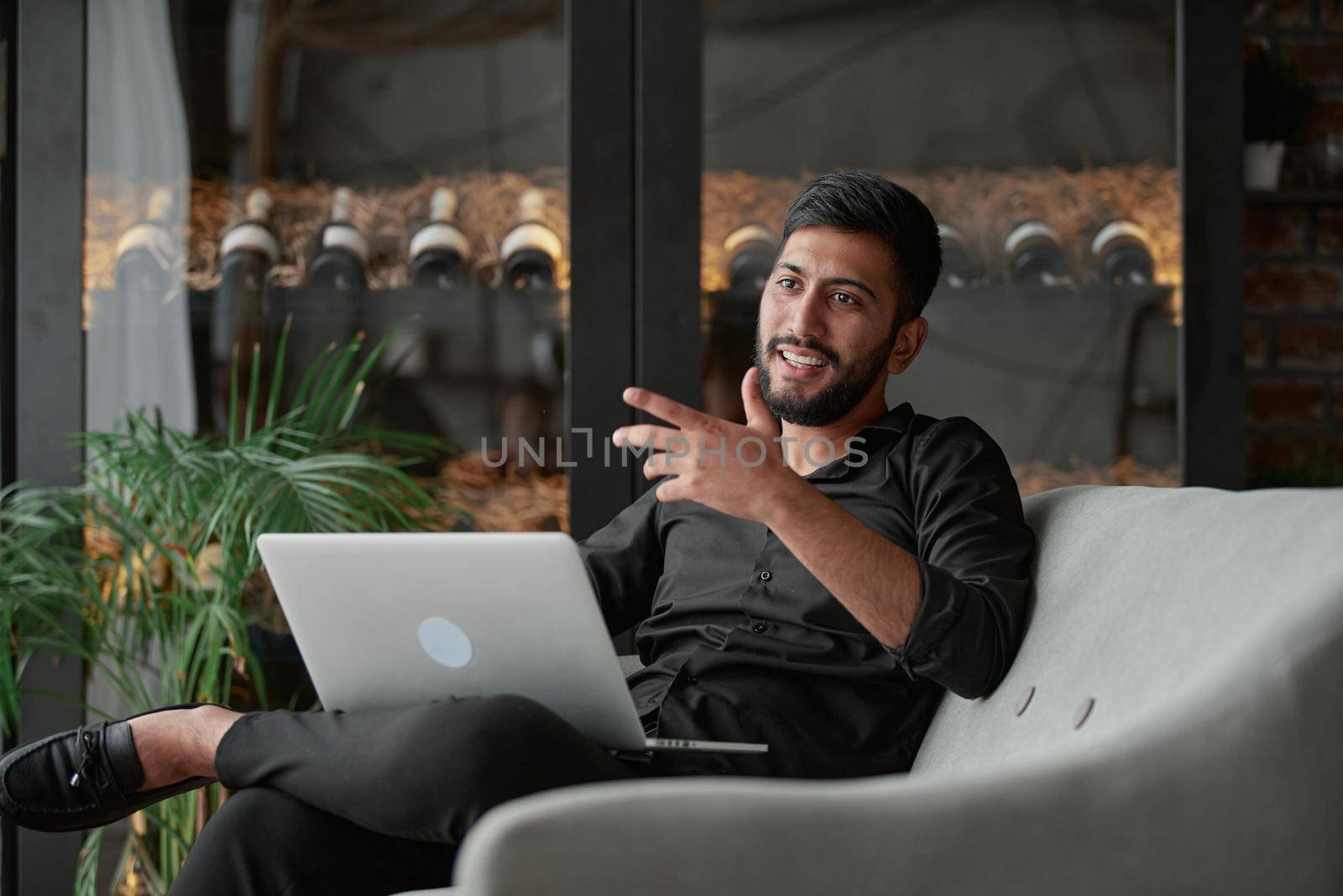 satisfied businessman with a laptop sitting in an armchair . by SmartPhotoLab