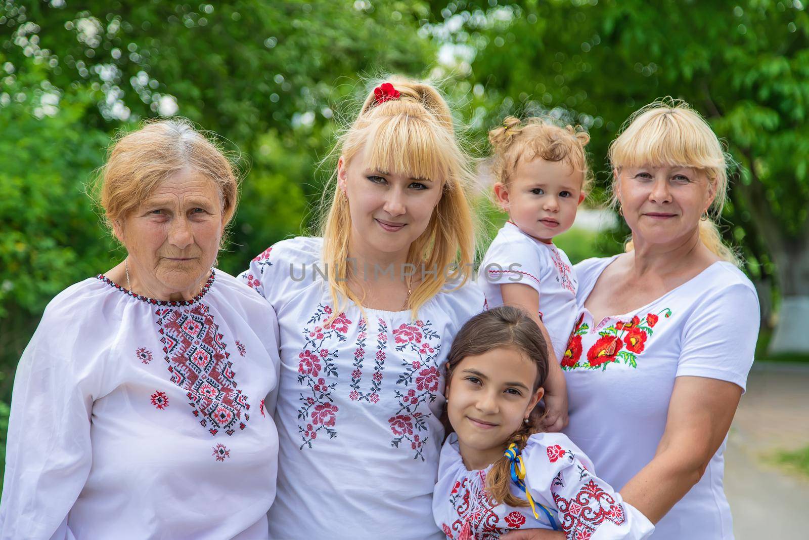 Family photo of a Ukrainian woman in embroidered shirts. Selective focus. by yanadjana