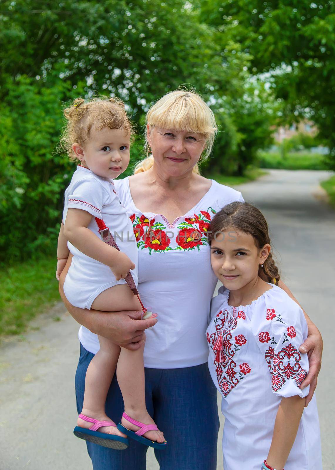 Family photo of a Ukrainian woman in embroidered shirts. Selective focus. by yanadjana