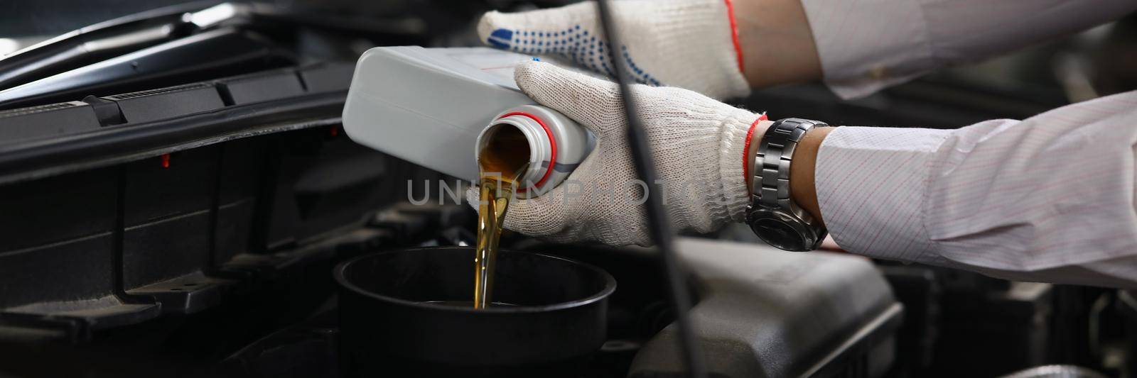 Close-up of refueling and pouring oil quality into engine motor car. Mechanic from maintenance service fix auto. Transmission and maintenance gear concept