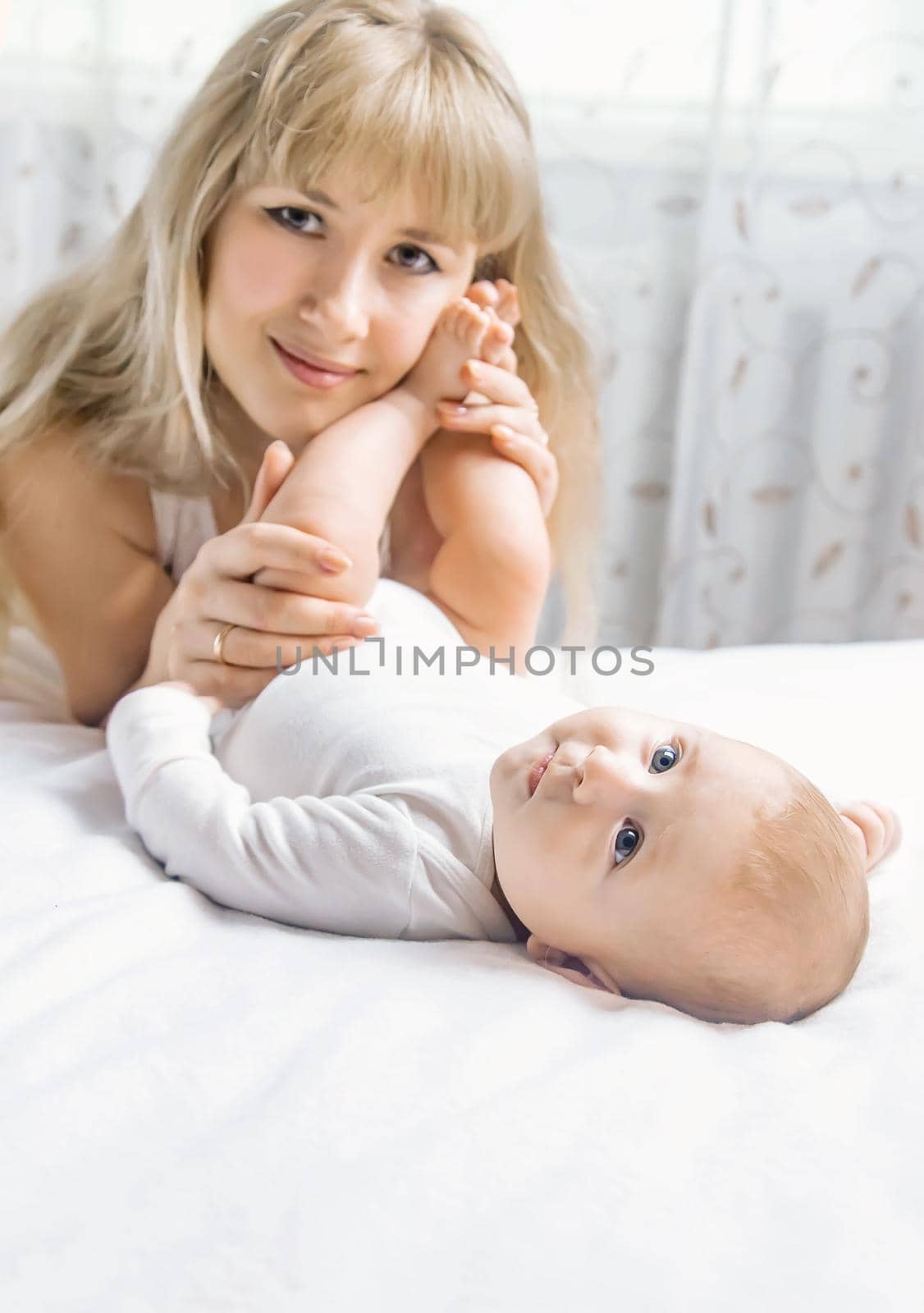 Mother with baby on a light background. Selective focus. People.