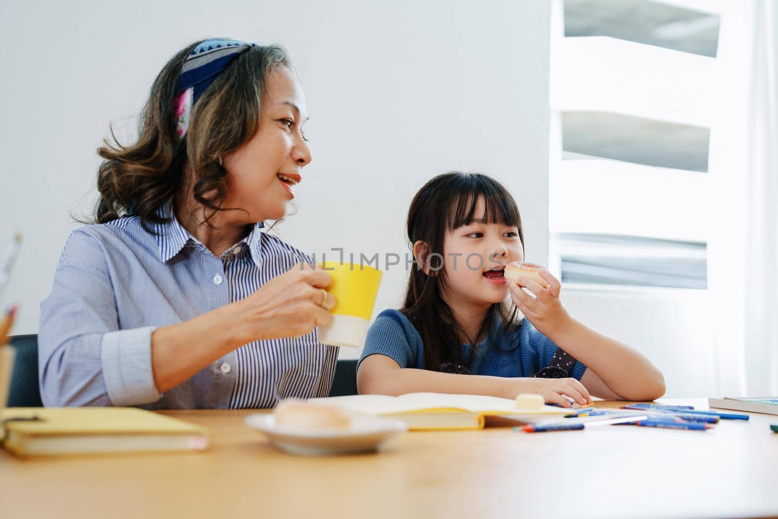 Asian portrait, grandchild granddaughter grandma grandmother and granddaughter happily join in activities to enjoy eating and enhance skills for grandchildren by Manastrong