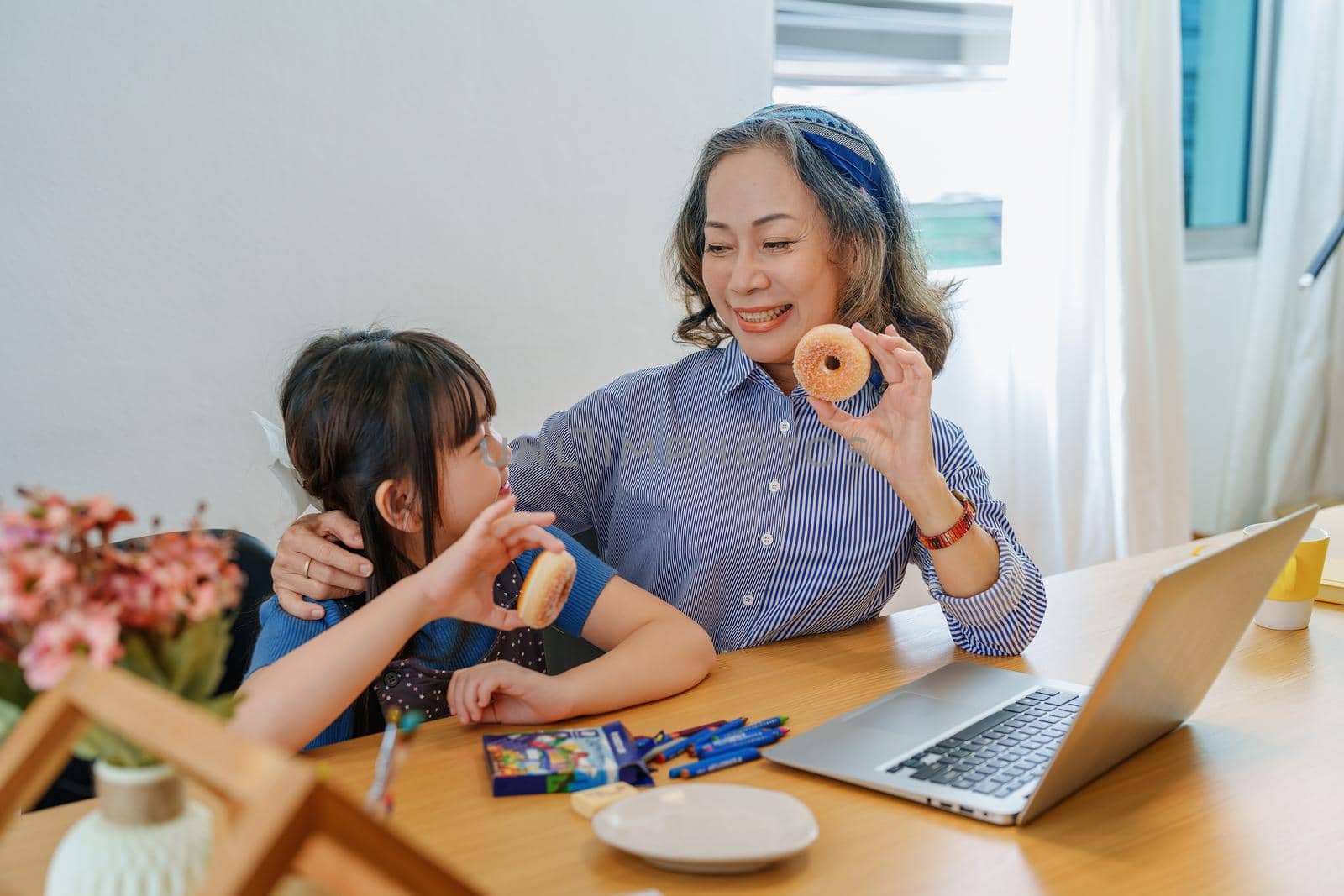 Asian portrait, grandchild granddaughter grandma grandmother and granddaughter happily join in activities to enjoy eating and enhance skills for grandchildren by Manastrong