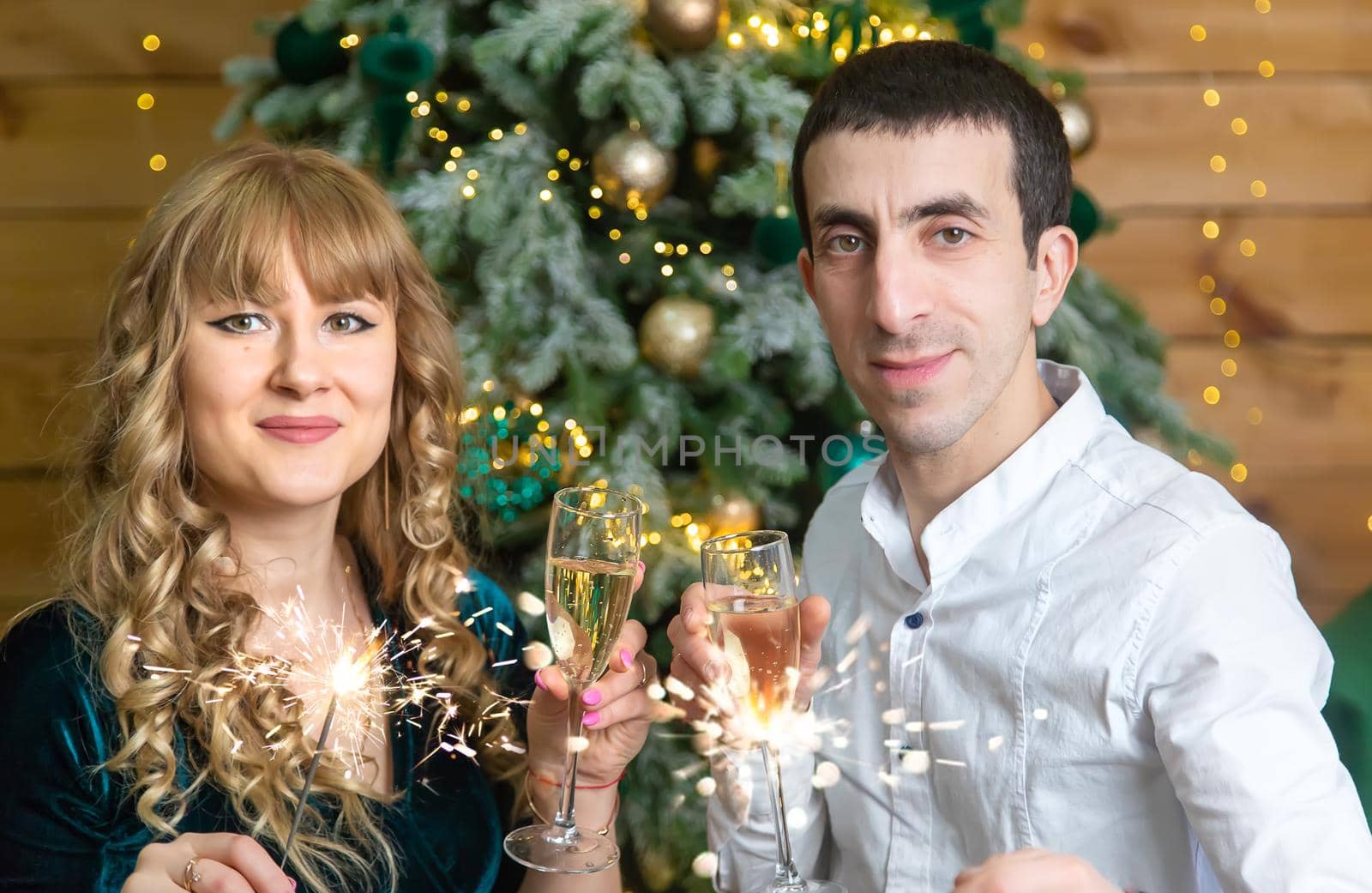 Christmas man and woman with glasses of champagne. Selective focus. Holiday.